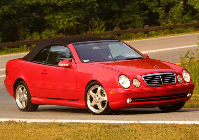 Red convertible with black soft top and alloy wheels