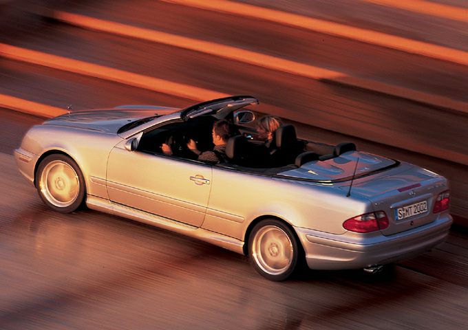 Convertible with open roof side view in motion