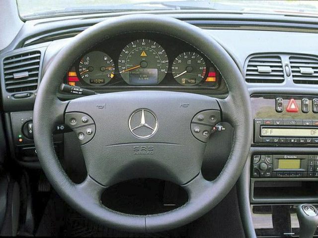 Steering wheel with gauge cluster and dashboard controls