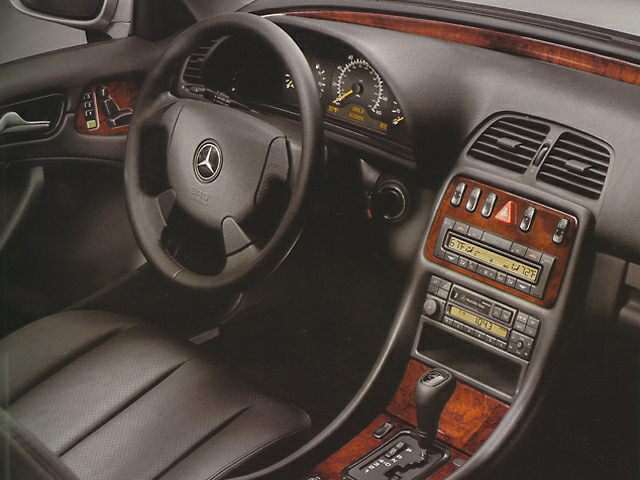 Dashboard and steering wheel with wood trim and instrument cluster