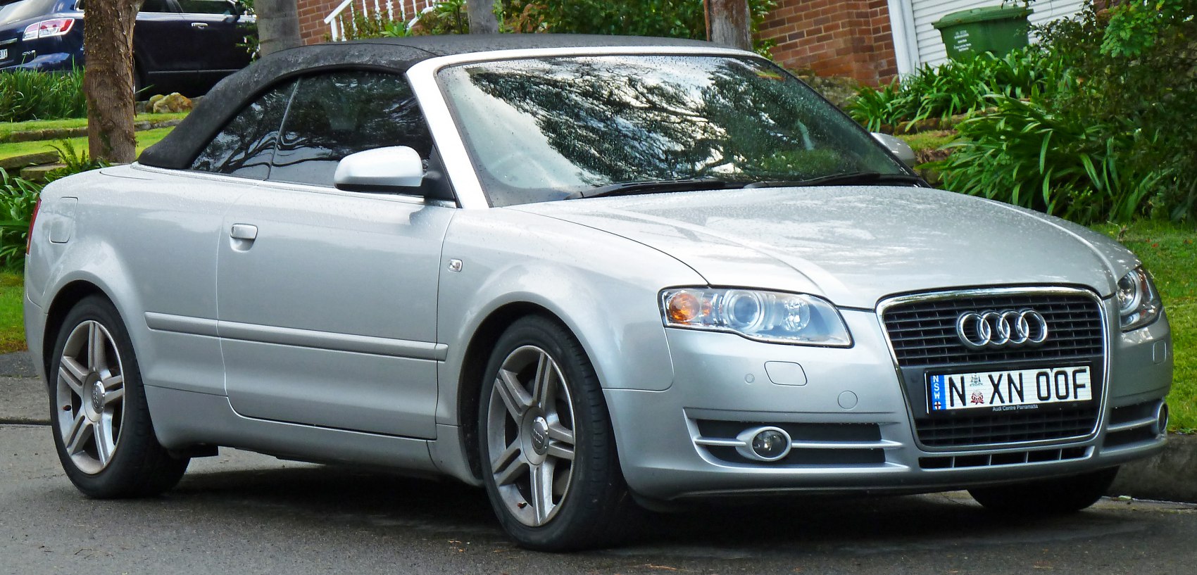 Silver convertible with front and side visible, soft top roof
