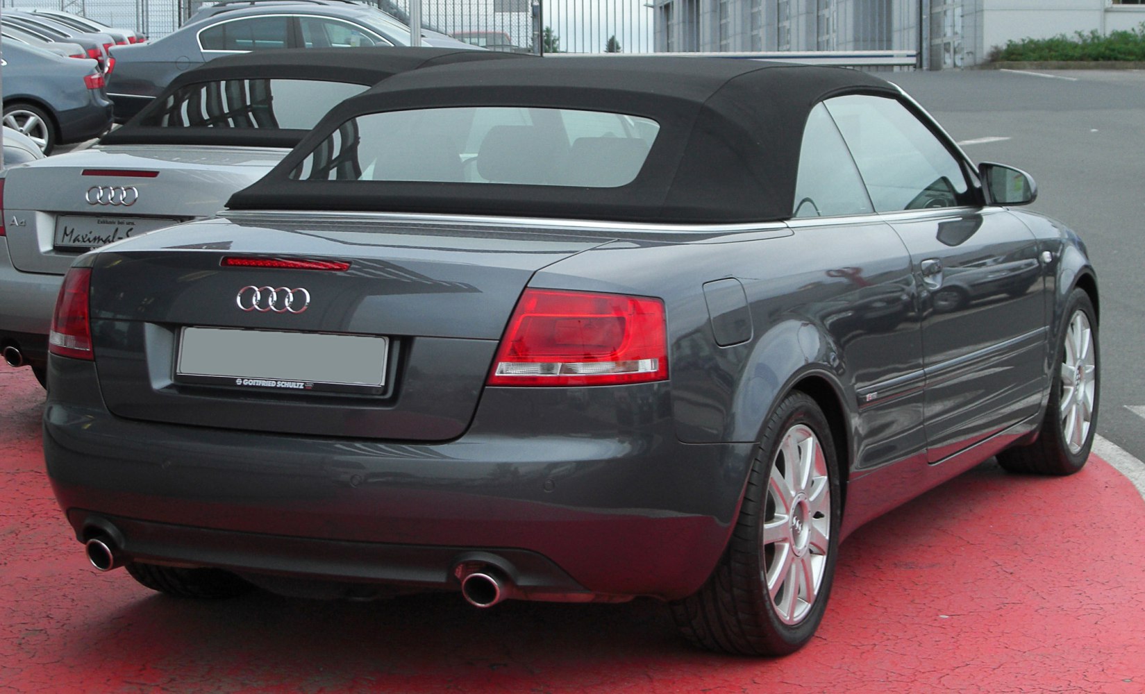 Convertible car rear with soft top roof and dual exhaust