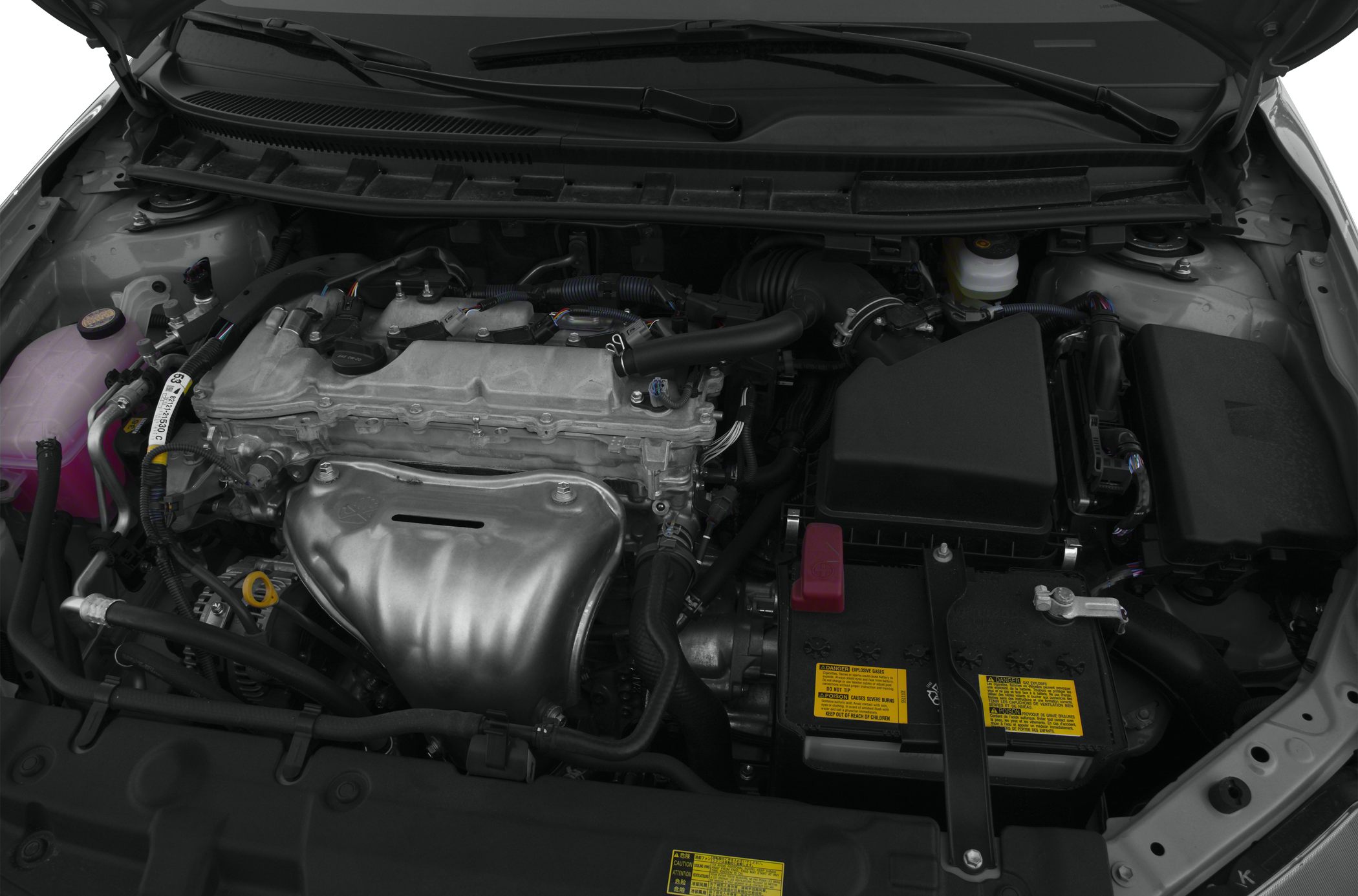 Engine bay showing exhaust manifold and battery compartment