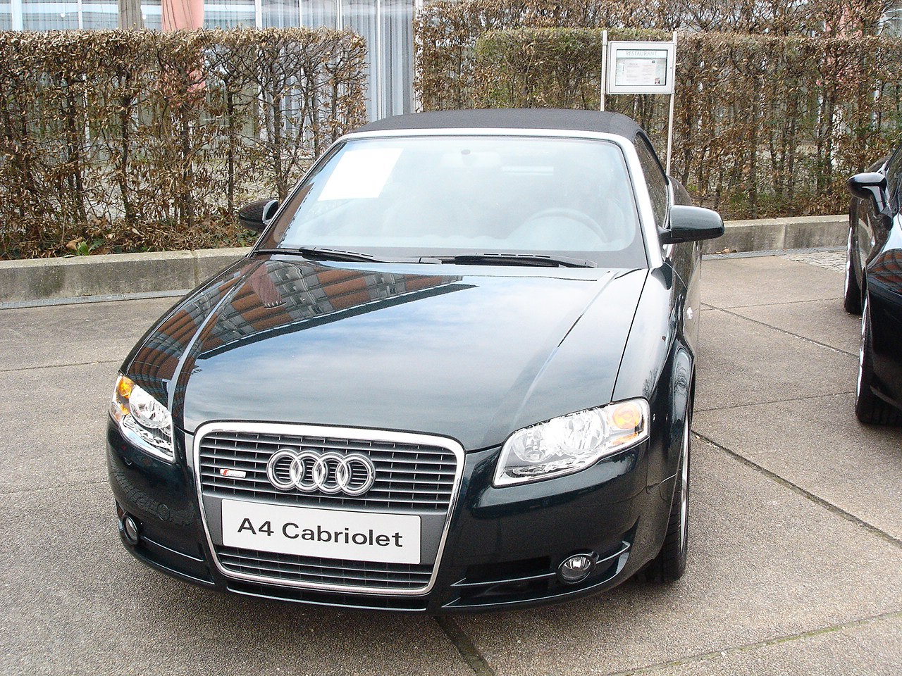 Front view of convertible with soft top roof and distinctive grille