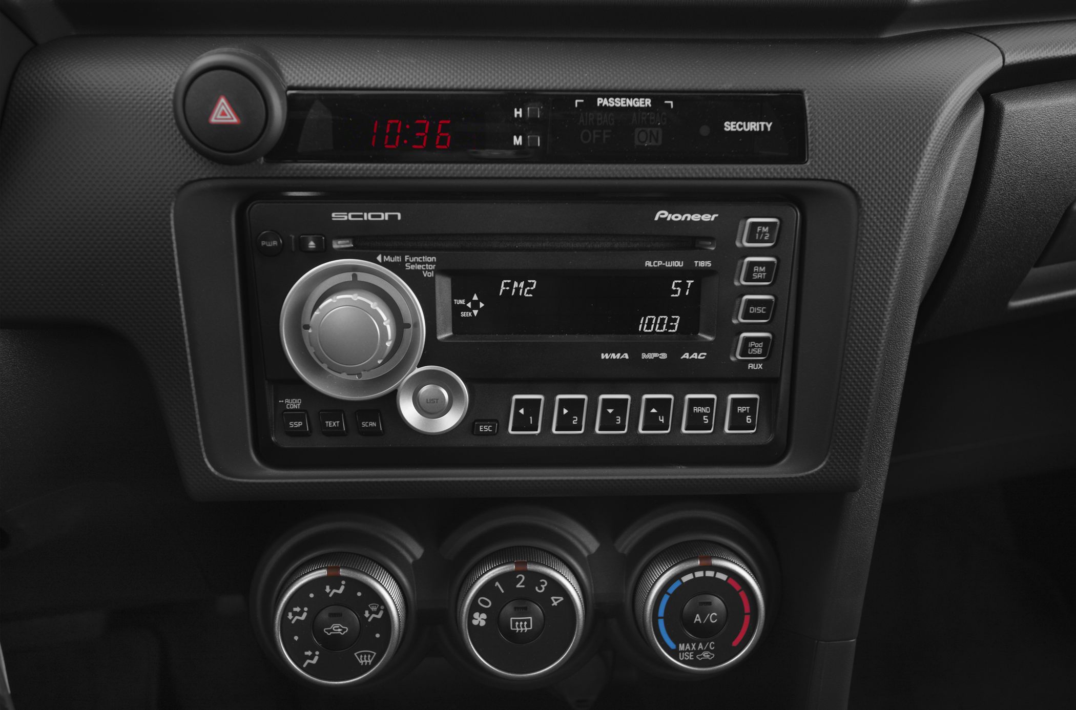 Car stereo and manual climate control knobs in dashboard center console