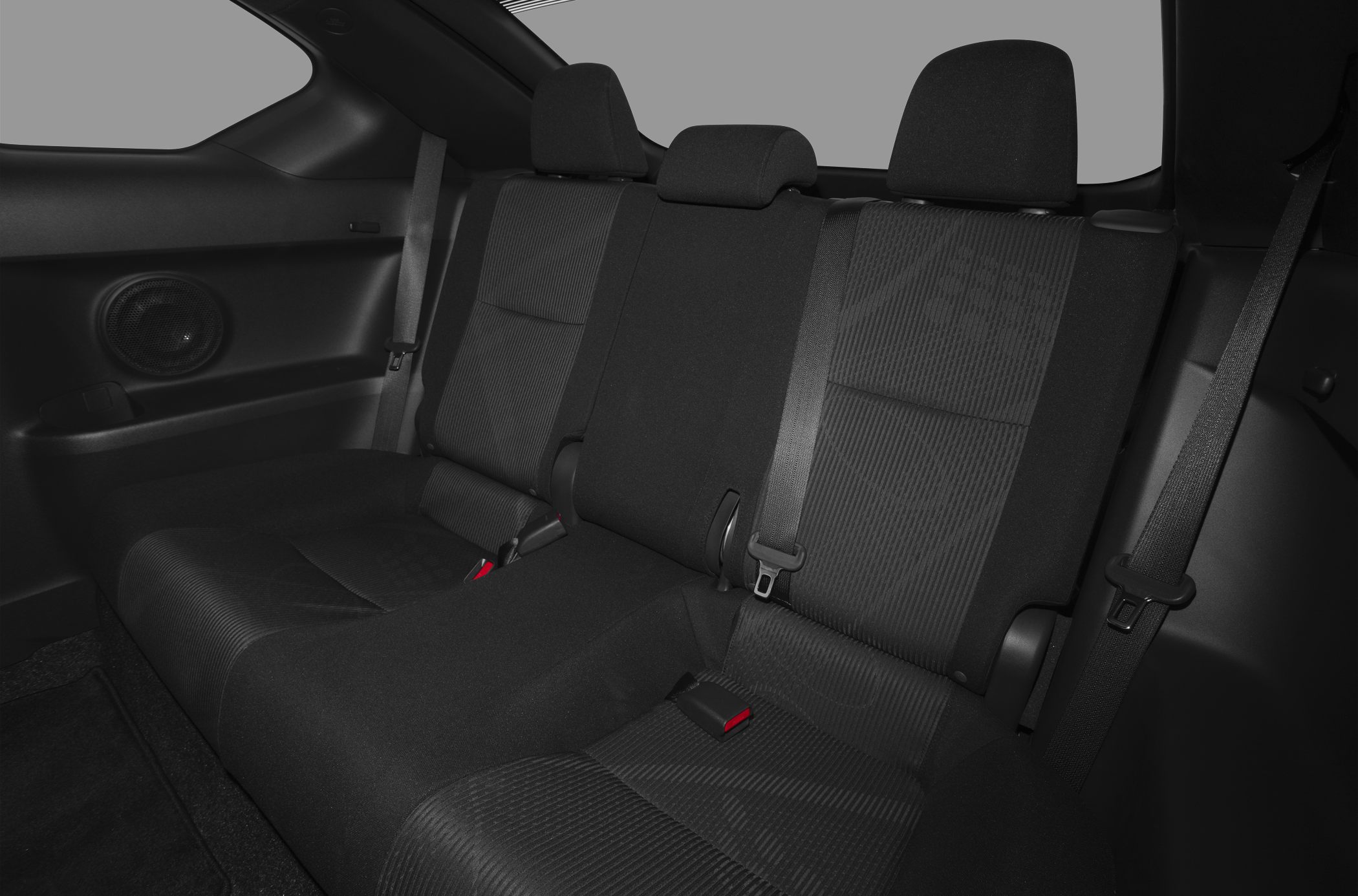 Rear car seat with fabric upholstery, seatbelts, and headrests