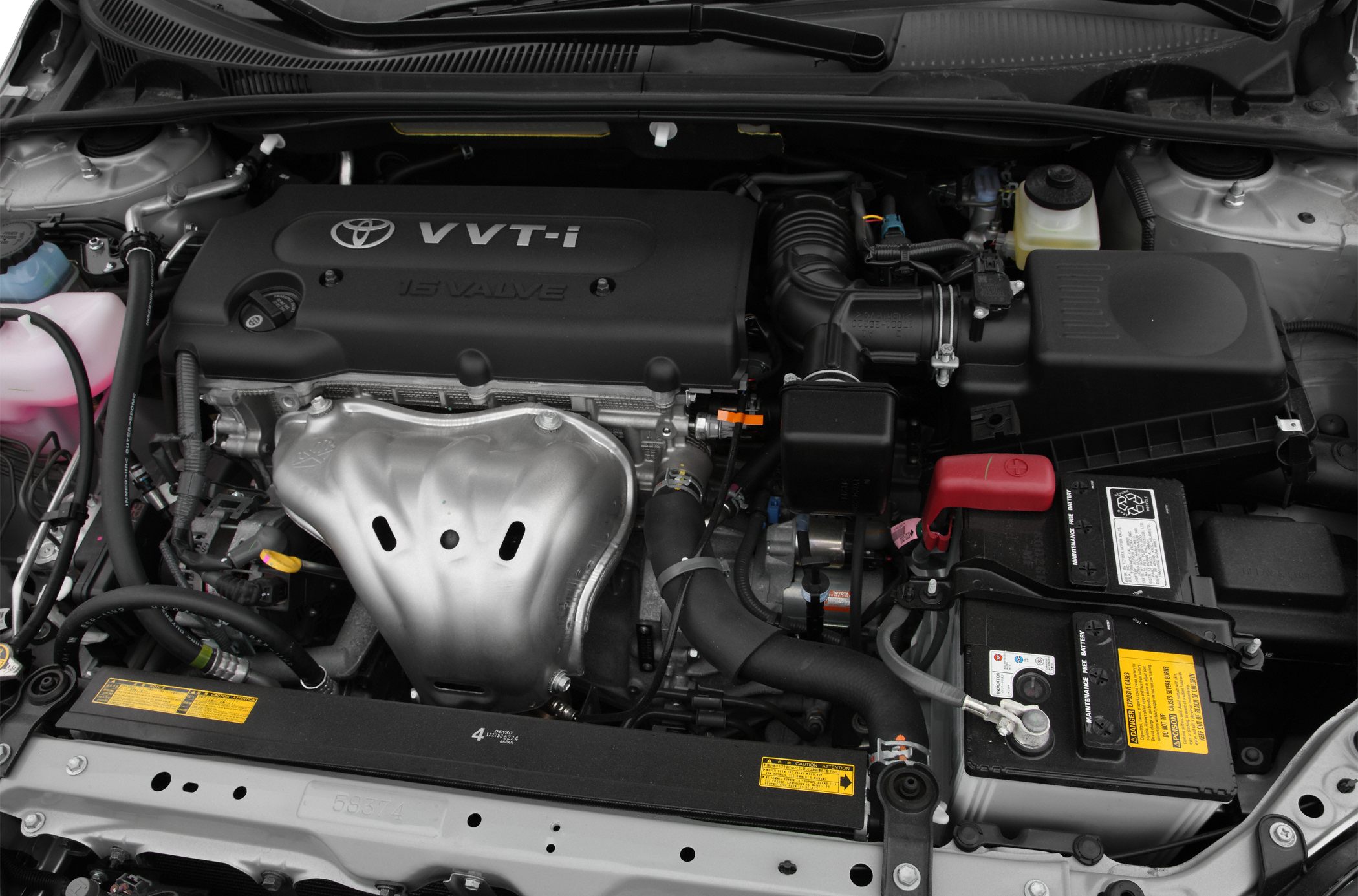 Engine bay with VVT-i 16 valve system and car battery.