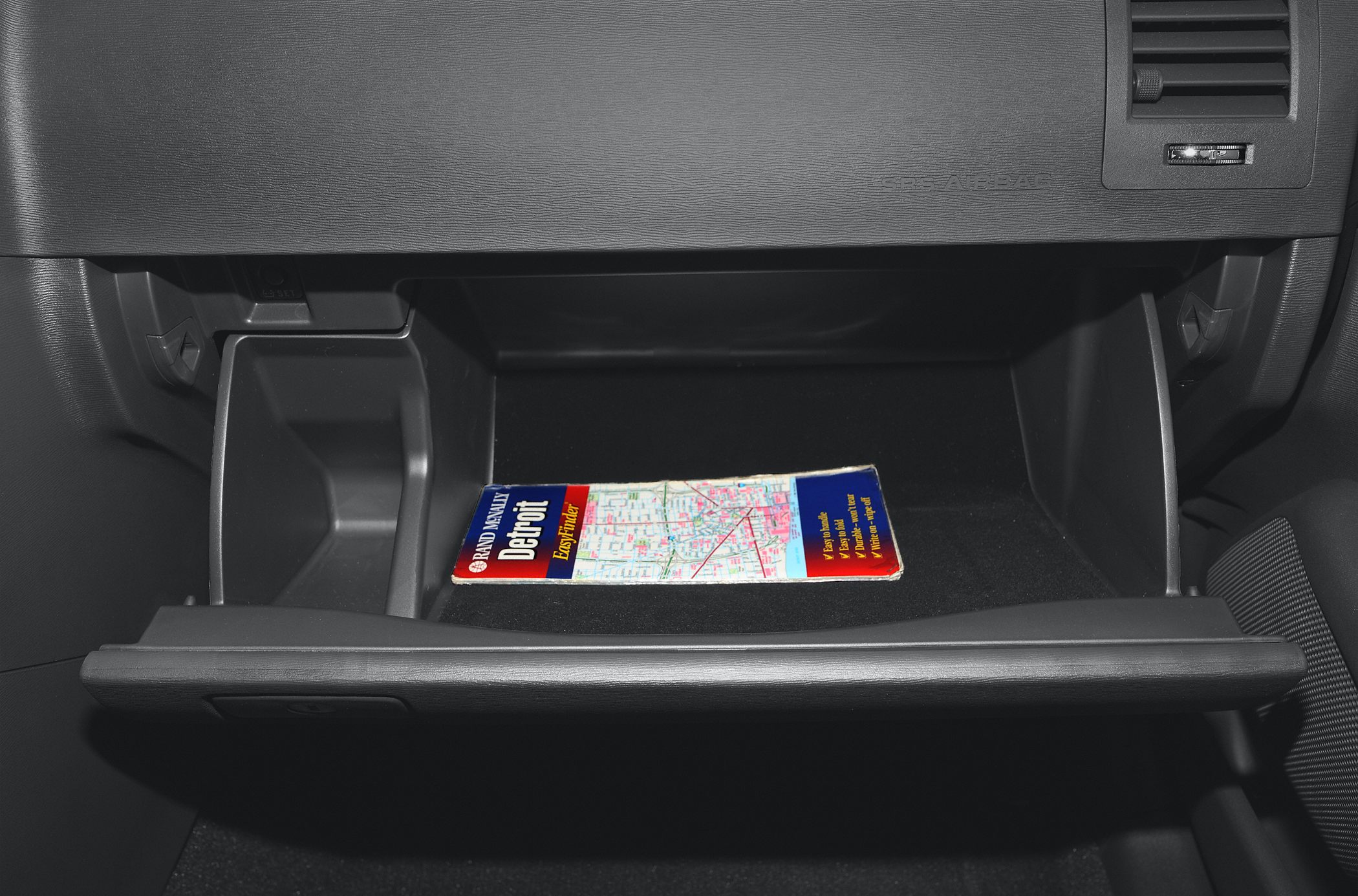 Glove compartment with map inside in car interior