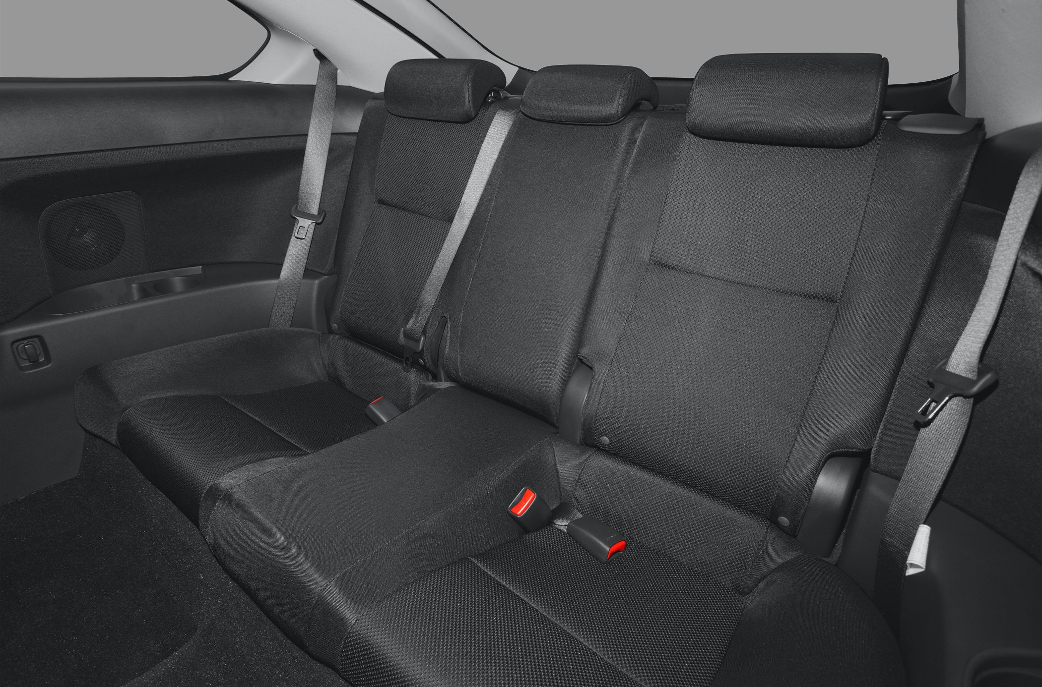 Rear seats with black fabric upholstery, three headrests, and seat belts