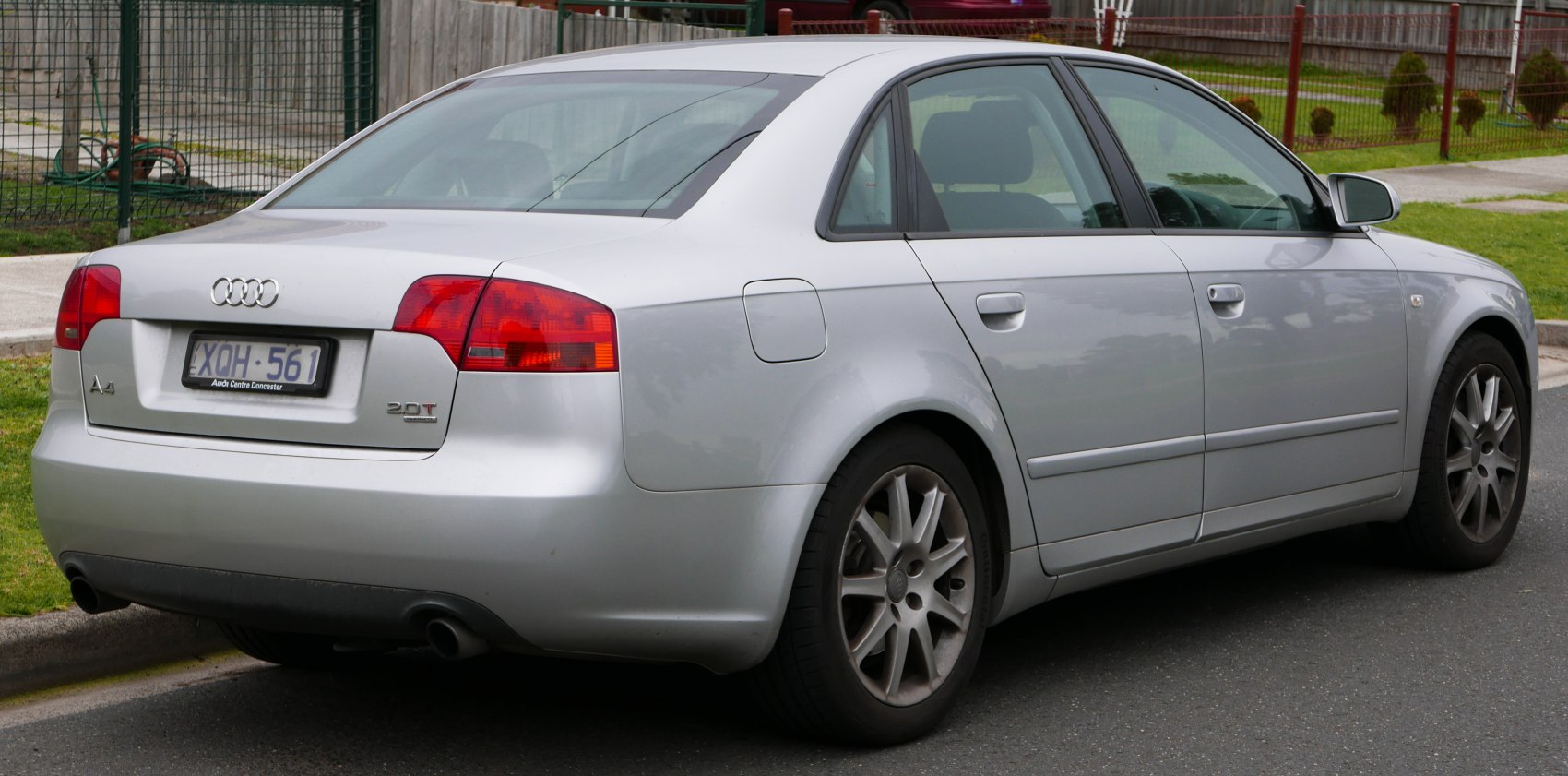 Silver sedan rear side with dual exhaust and alloy wheels