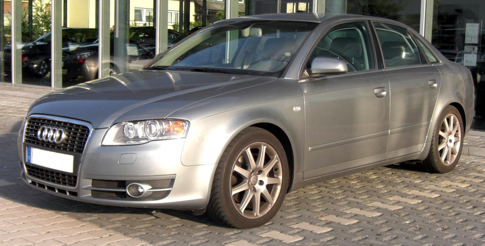 Silver sedan front side with grille and alloy wheels