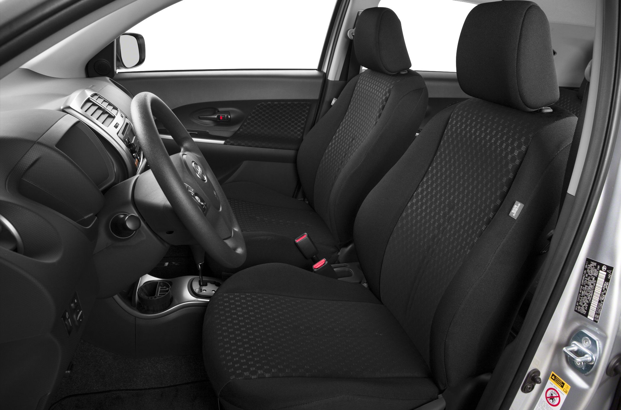 Cloth upholstery seats and steering wheel in compact hatchback interior