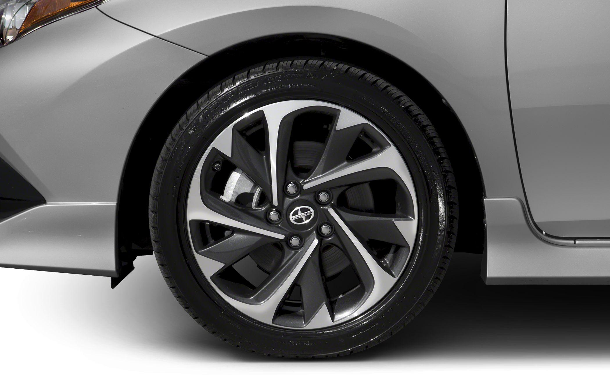 Close-up of alloy wheel and tire tread on car