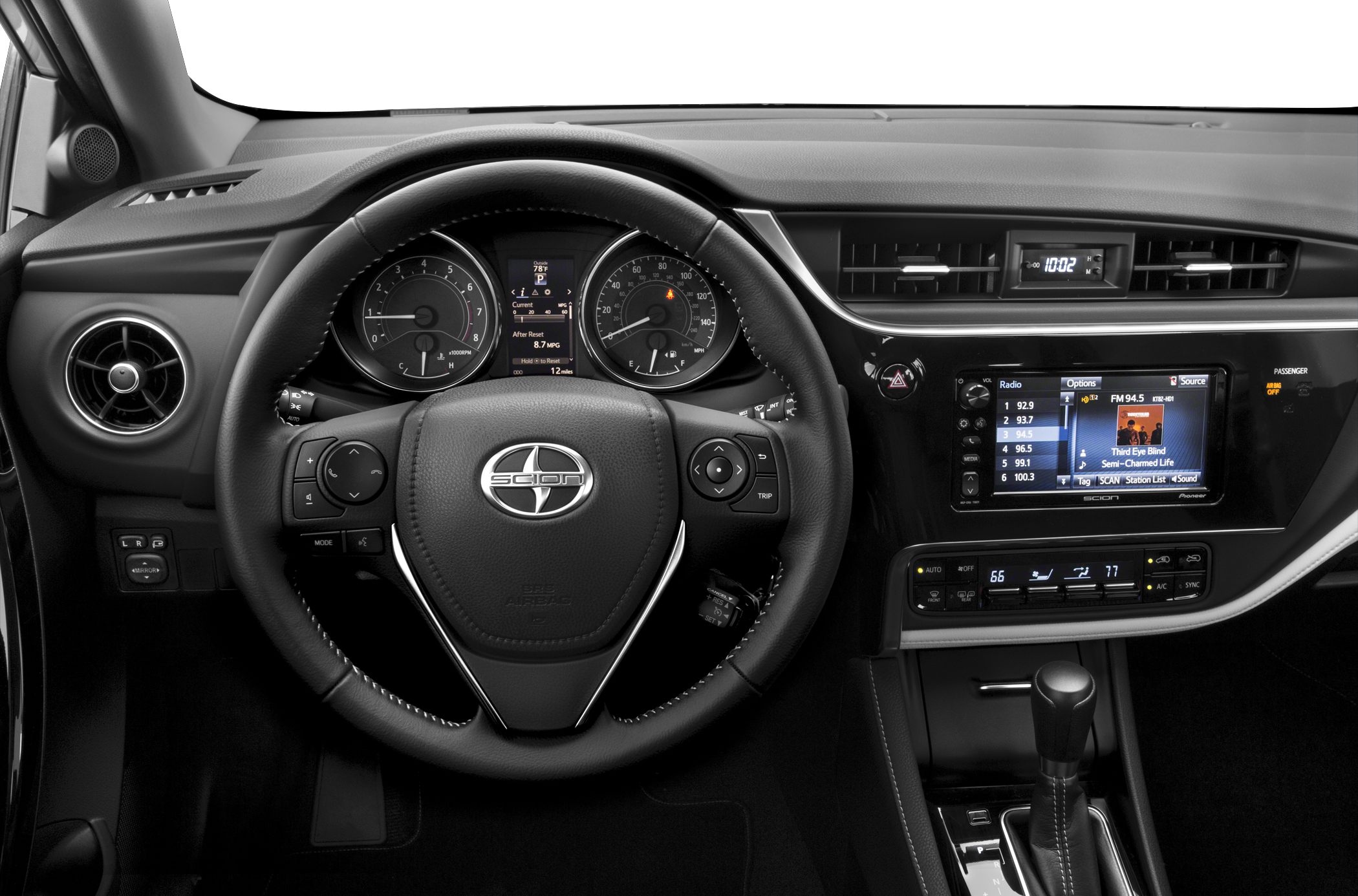 Dashboard with steering wheel, digital display, infotainment screen, and climate control panel