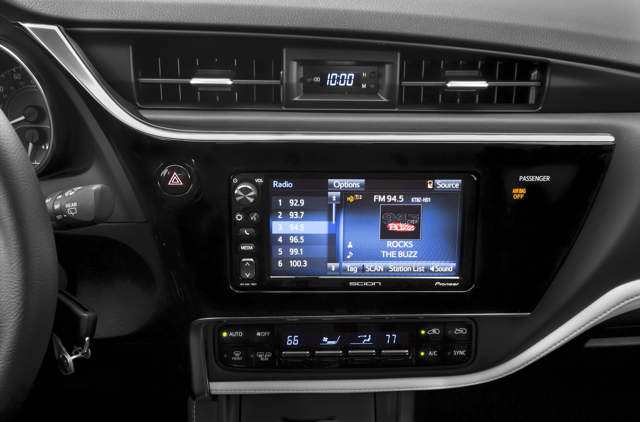 Car interior with touchscreen radio and dual zone climate control panel
