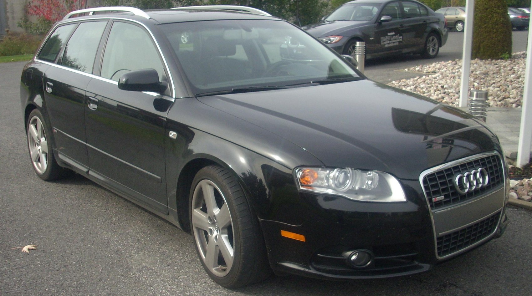 Black station wagon front-angle with alloy wheels