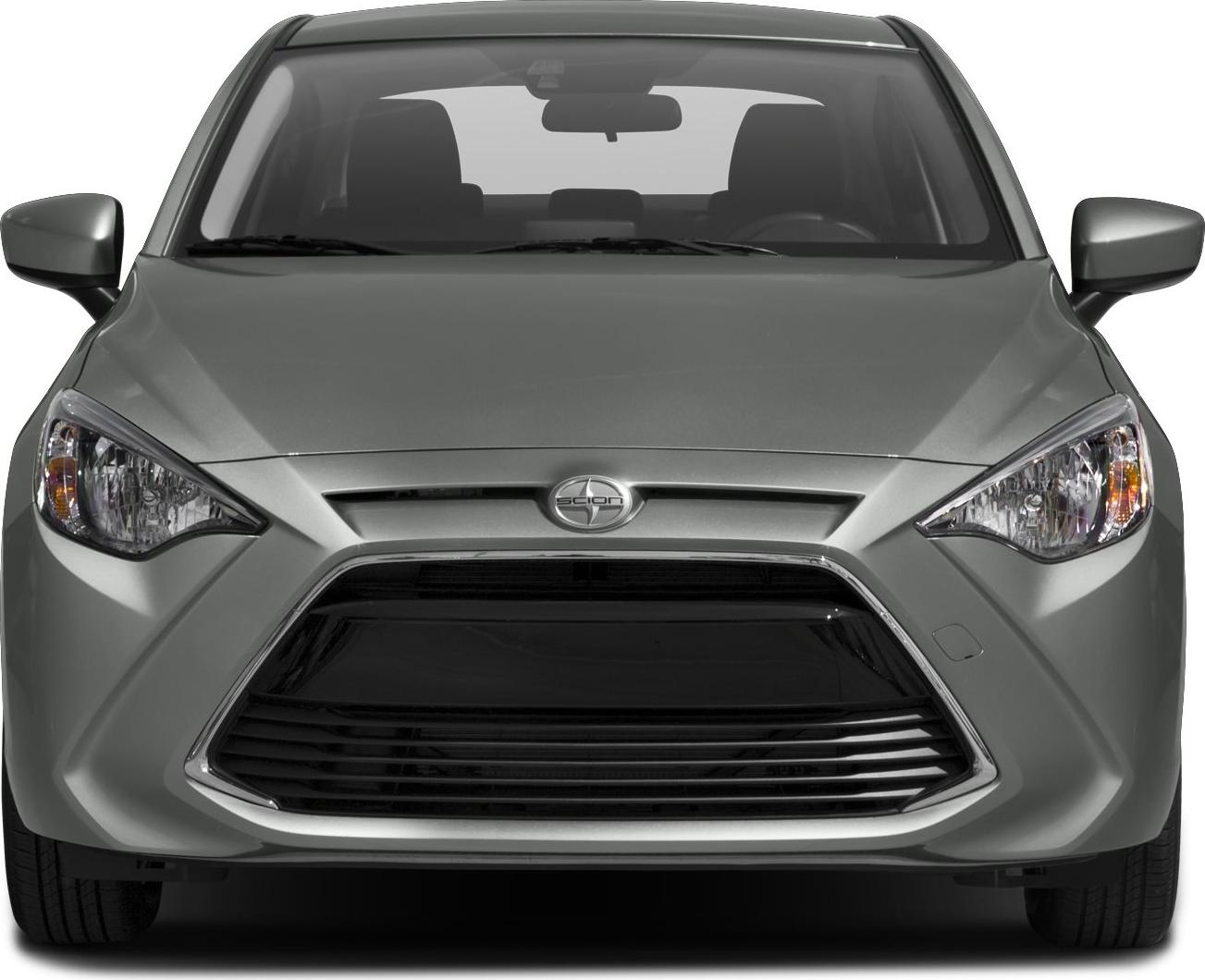 Sharp headlights and bold front grille of a compact sedan