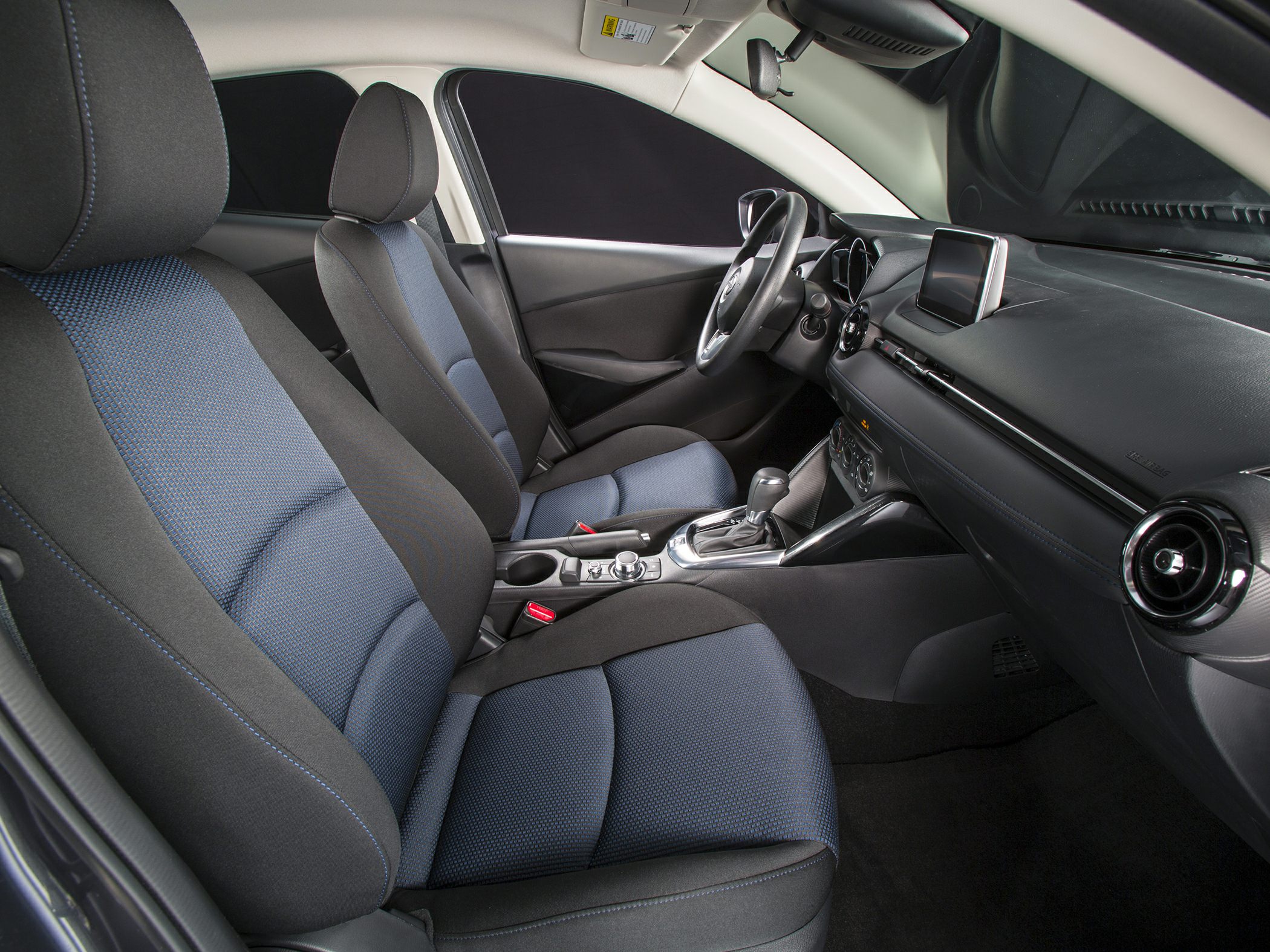 Front seats and dashboard interior with touchscreen and automatic gear shifter