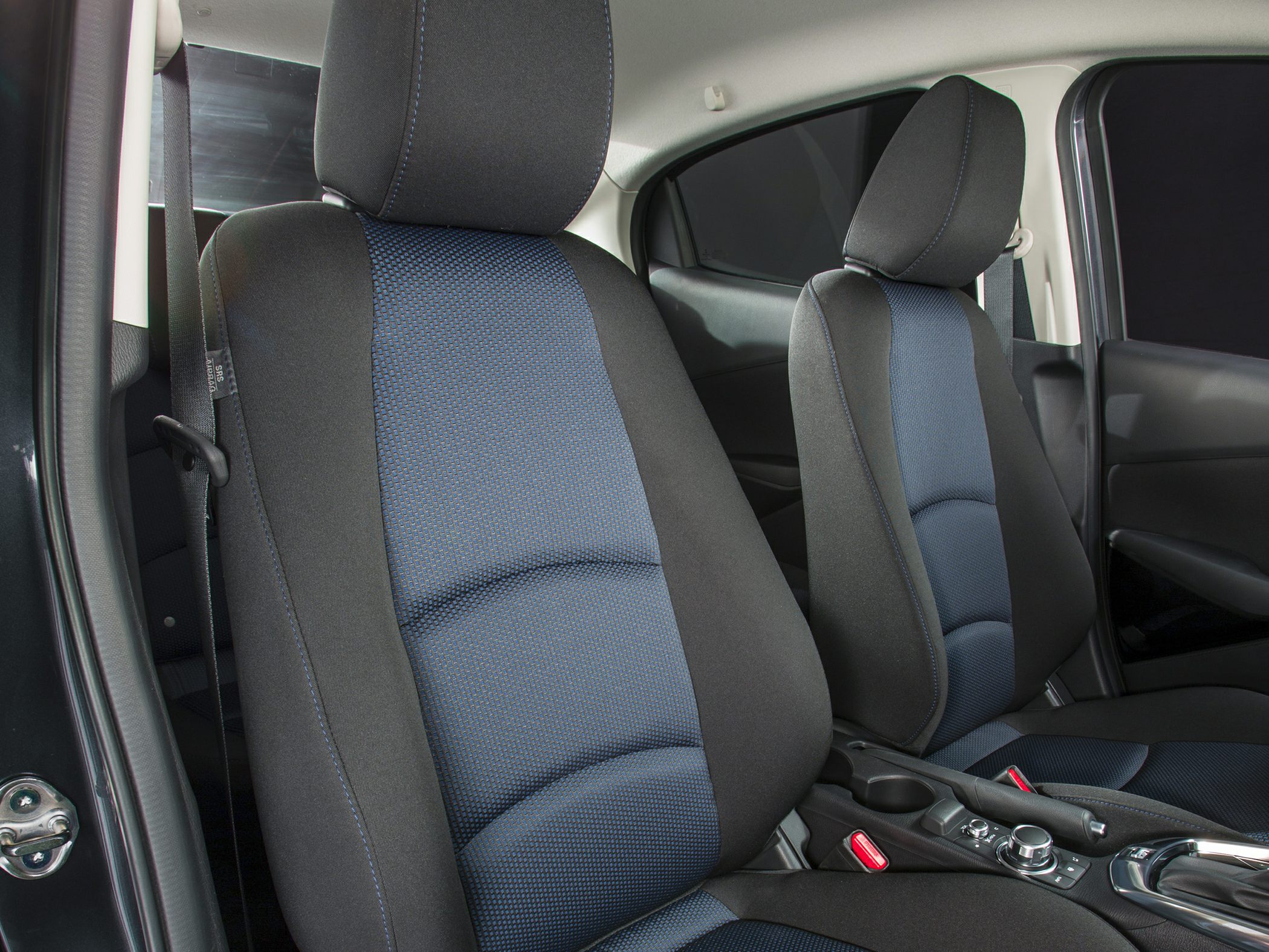Fabric car seats with blue center upholstery and center console controls