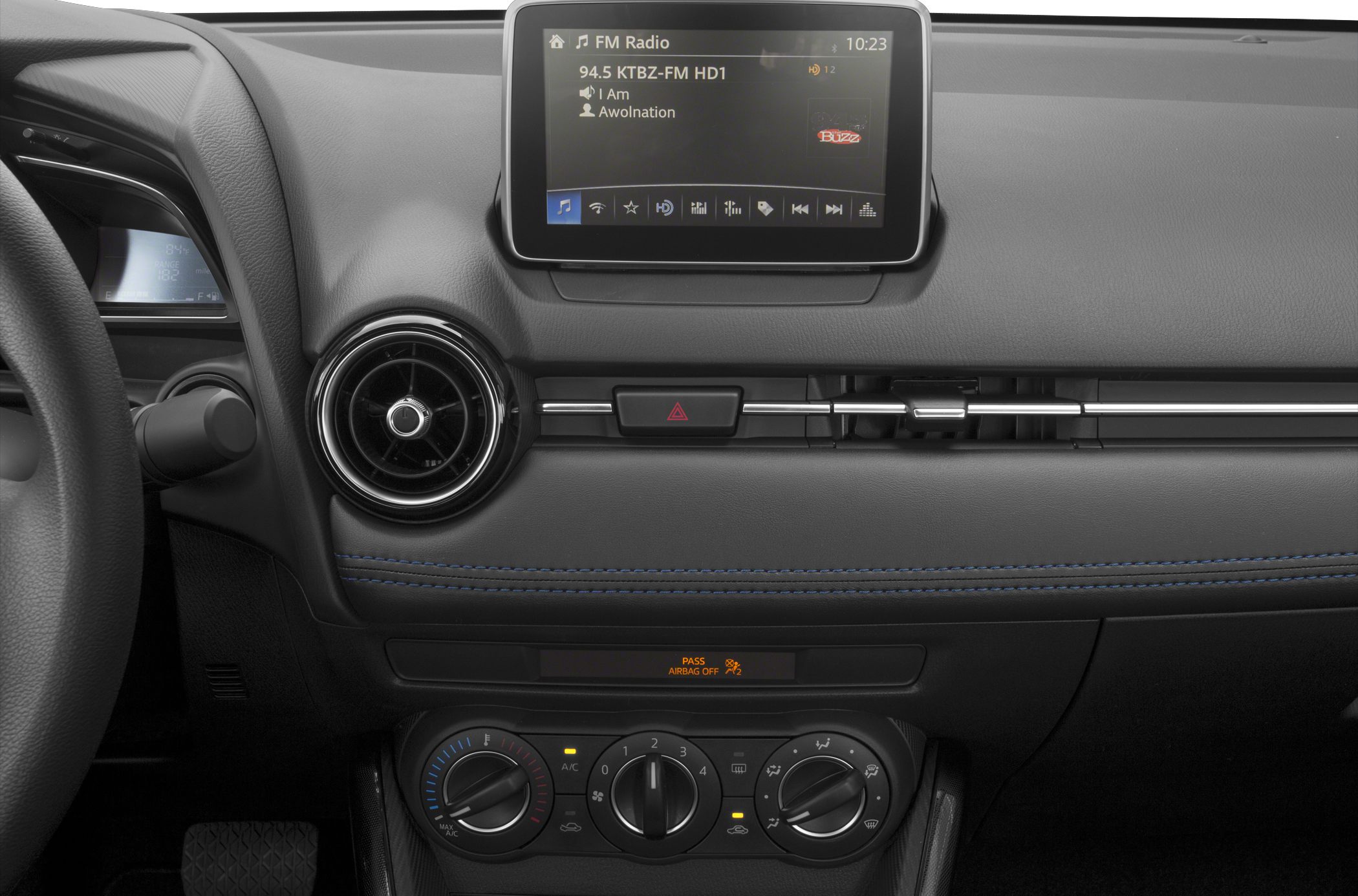 Dashboard with touchscreen, circular air vents, manual climate controls