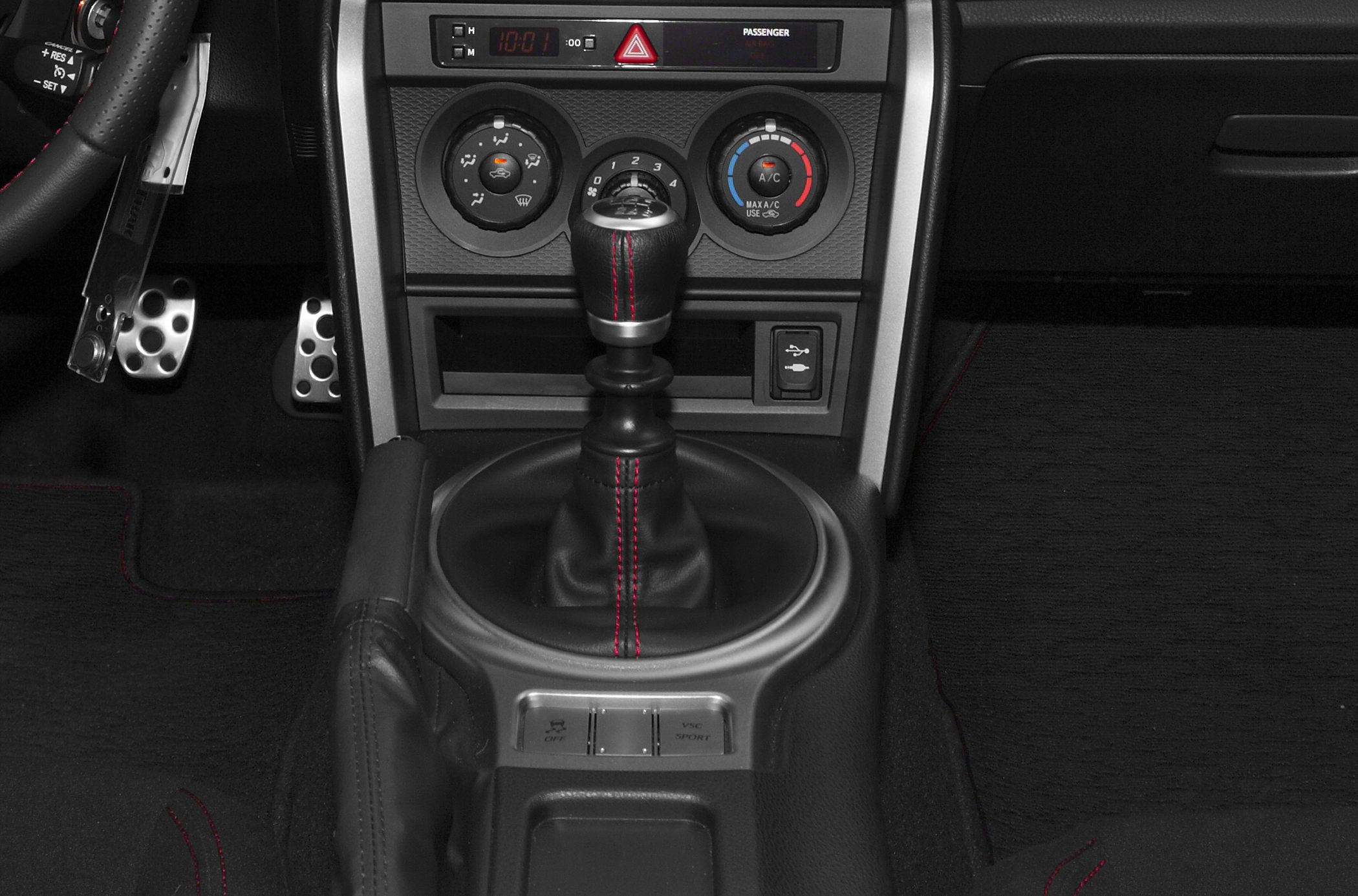 Manual gear shift with red stitching and center console controls