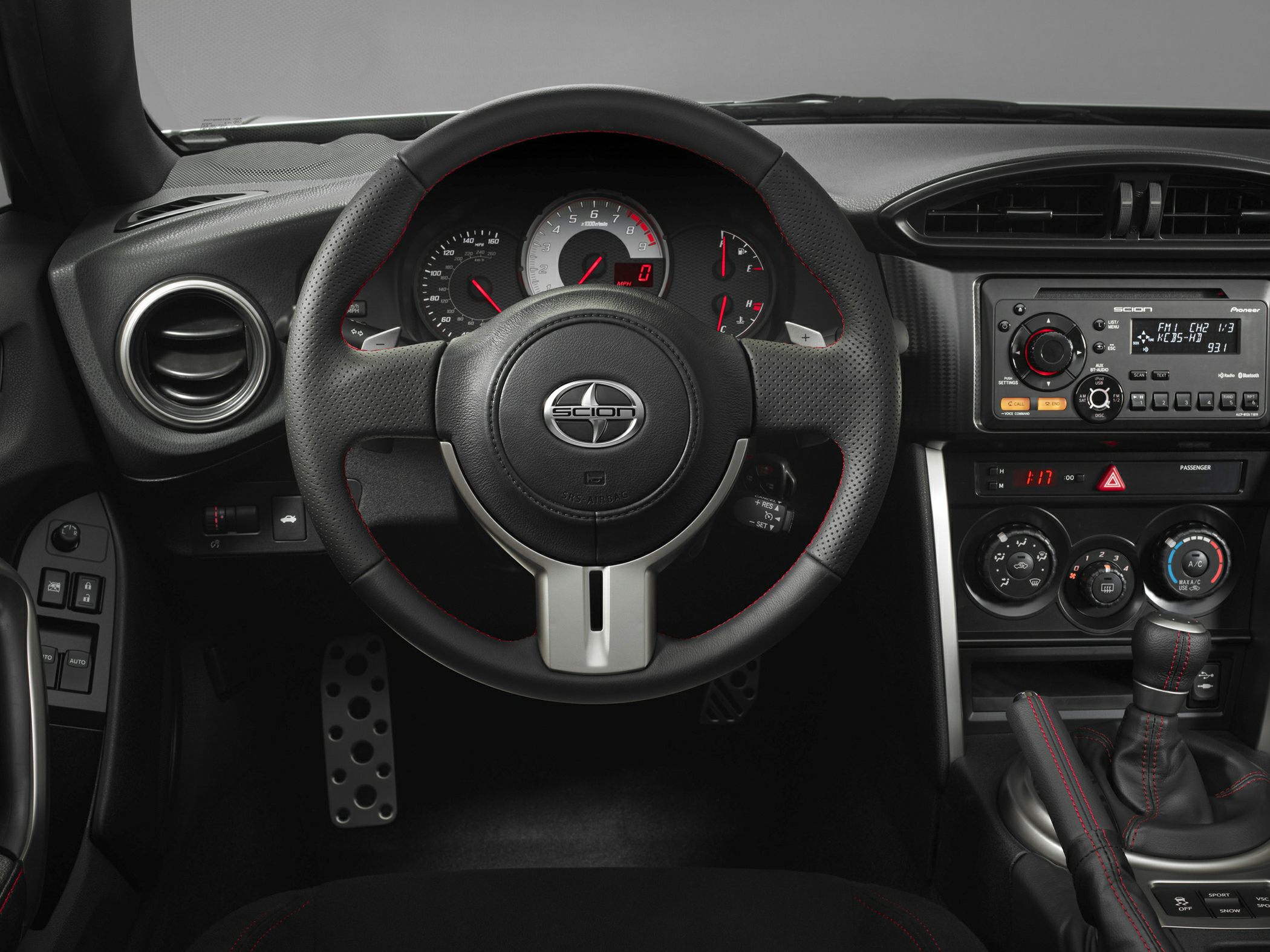 Sporty steering wheel and dashboard controls with manual gear shifter