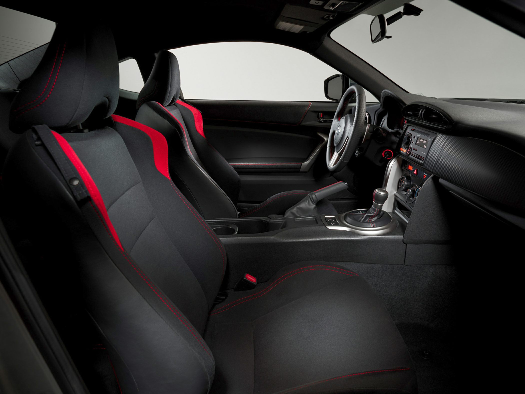 Red-accented bucket seats and modern dashboard interior design