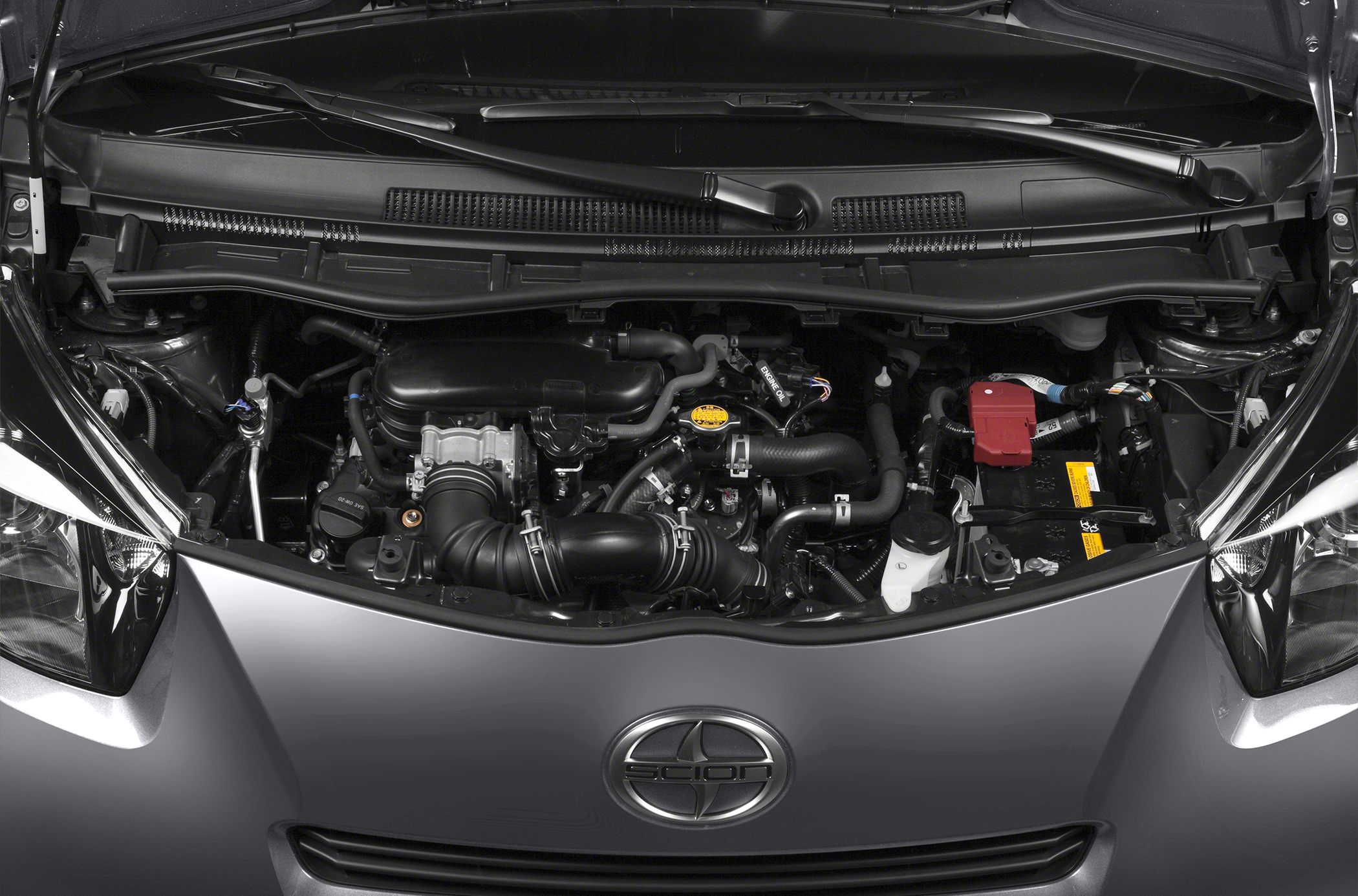 Compact engine bay with detailed automotive components and battery