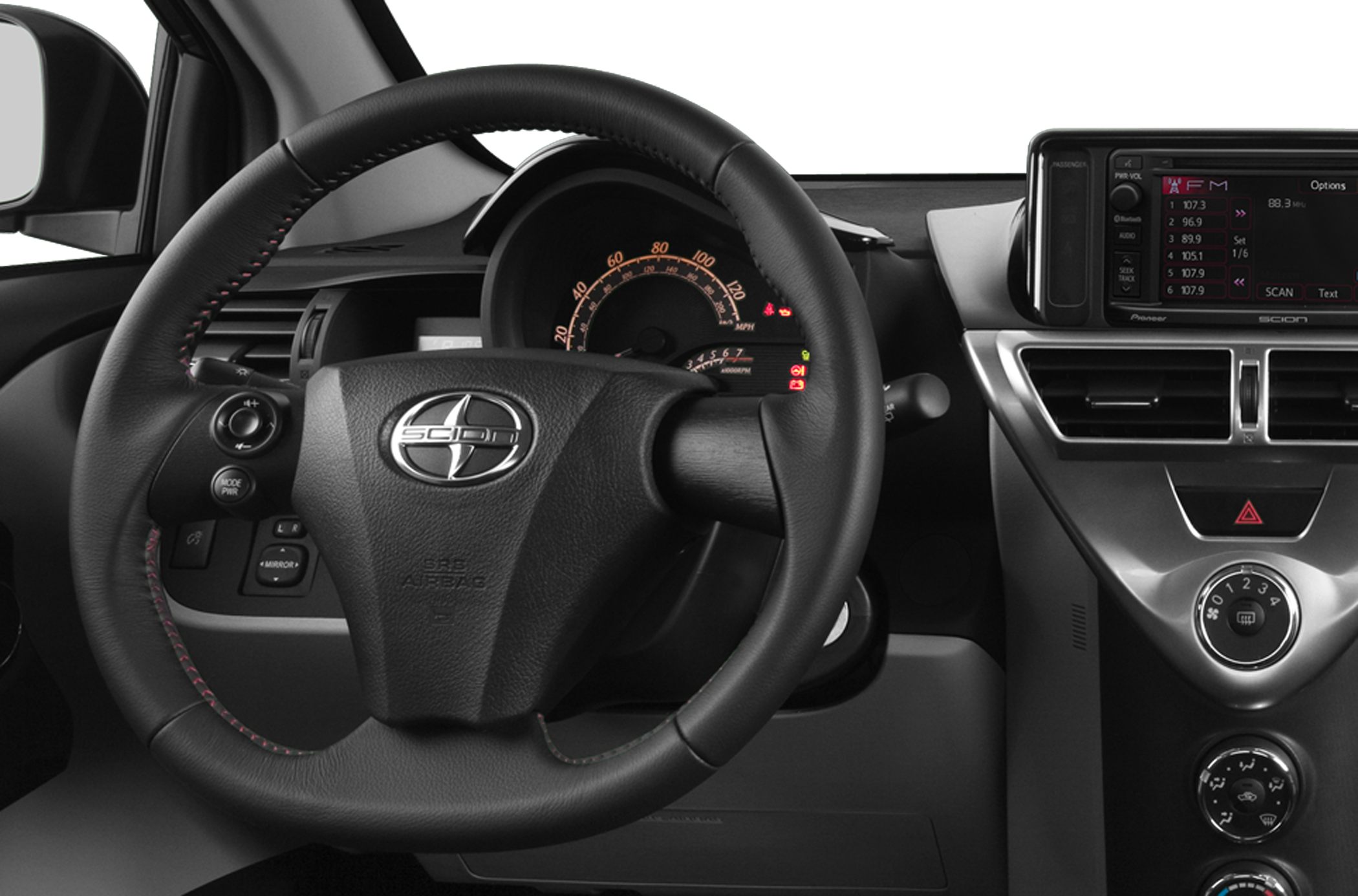 Steering wheel with controls and compact dashboard with instrument cluster and infotainment screen