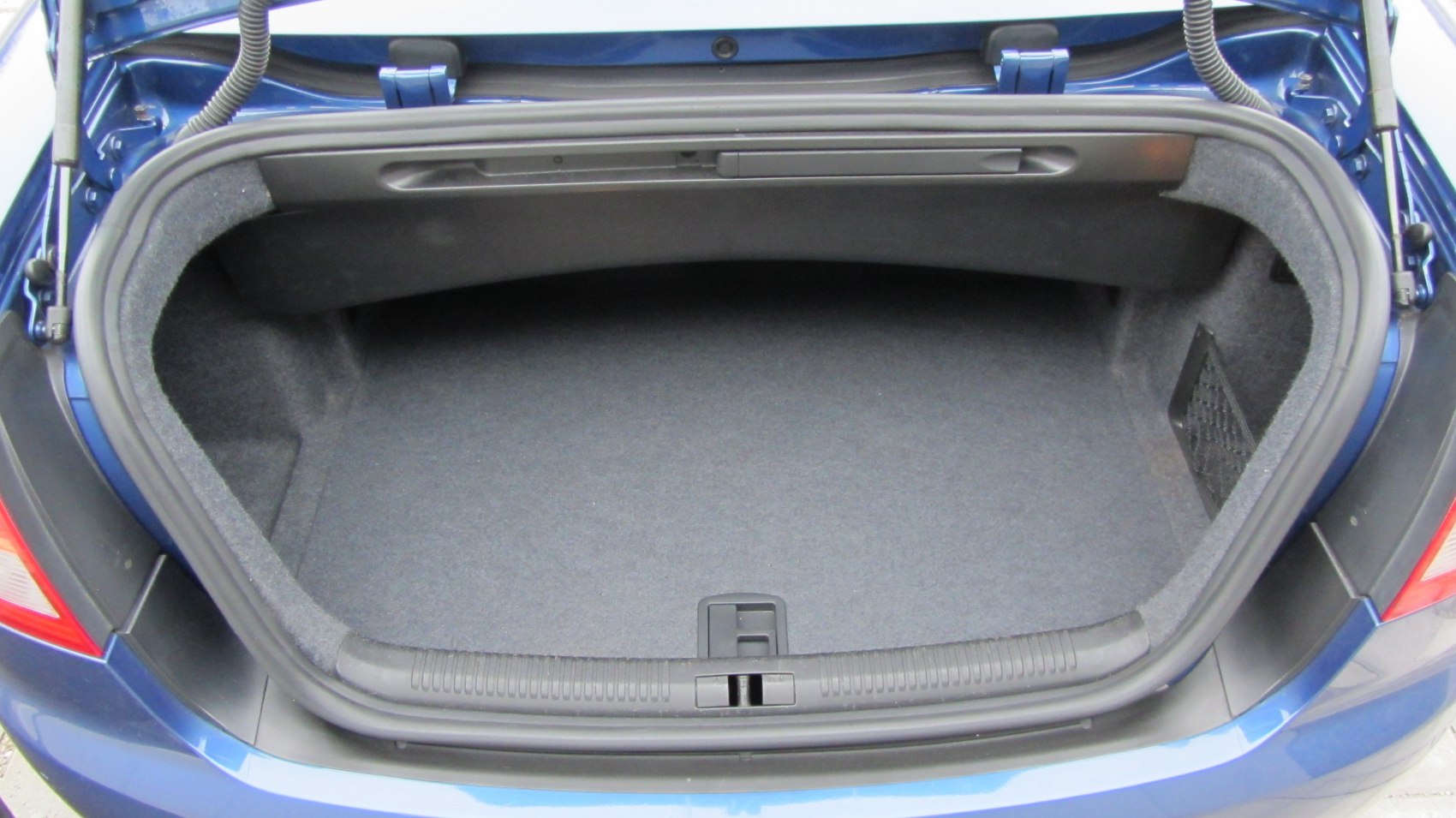 Spacious and clean car trunk interior with padded lining and practical layout