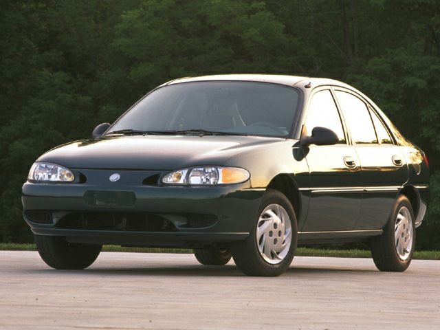 Front view of four-door sedan with distinctive dual headlight assembly and smooth body lines.