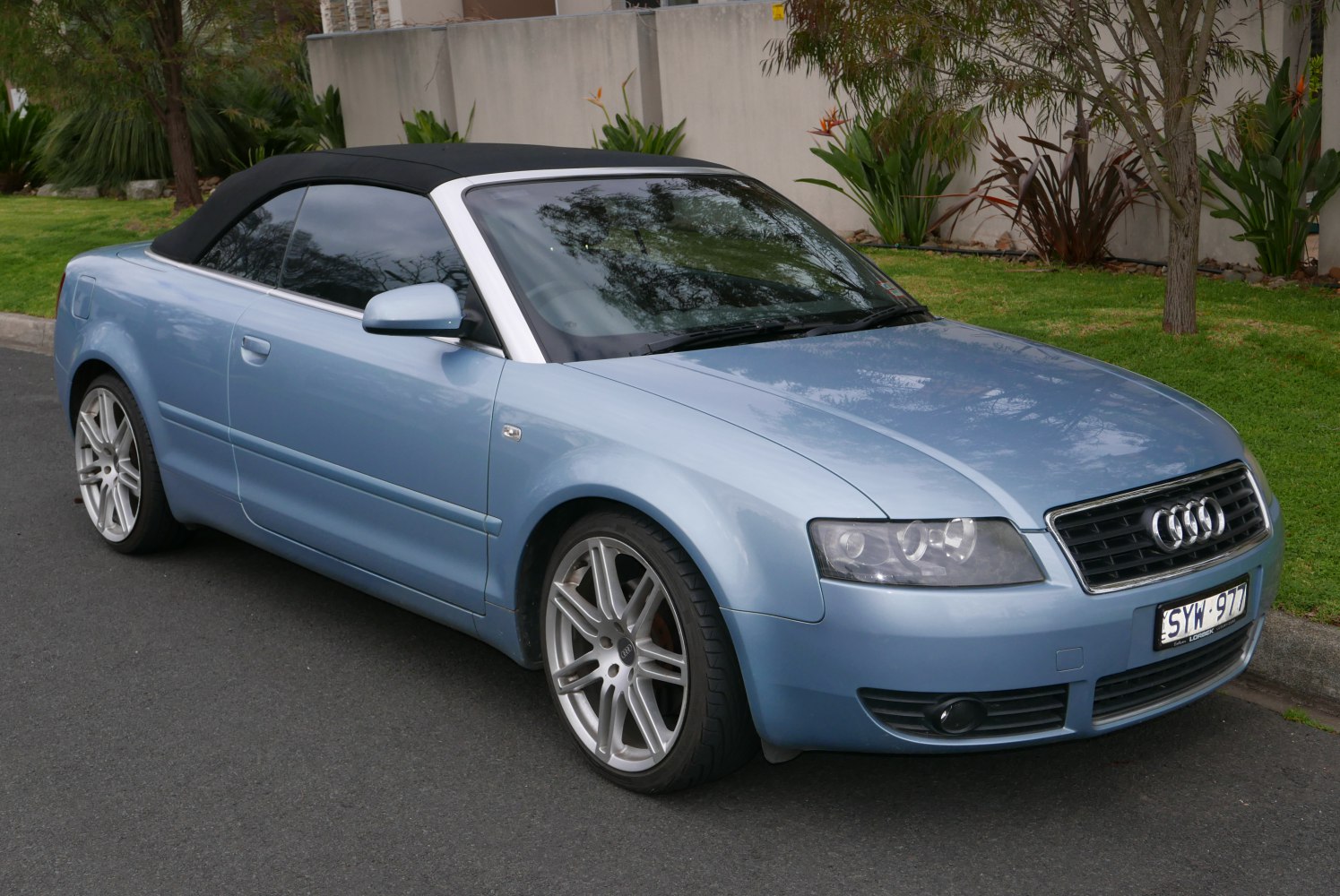 Blue convertible with soft top and alloy wheels