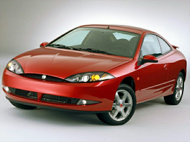 Red two-door coupe with sleek headlights and aerodynamic front side view