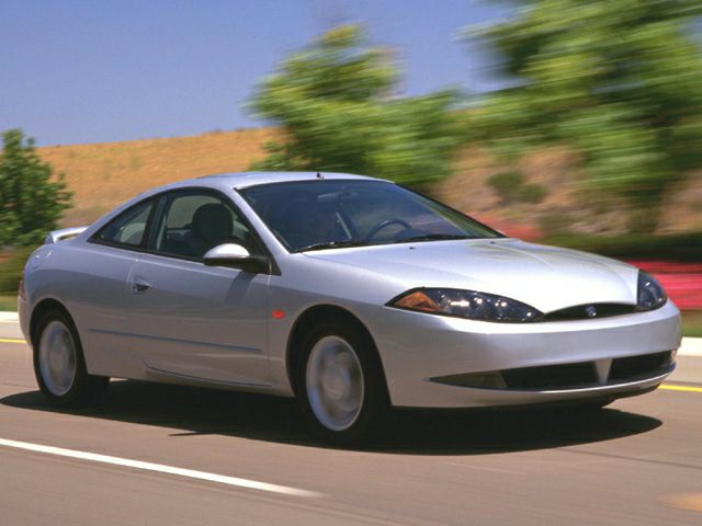 Silver sporty coupe driving on a road