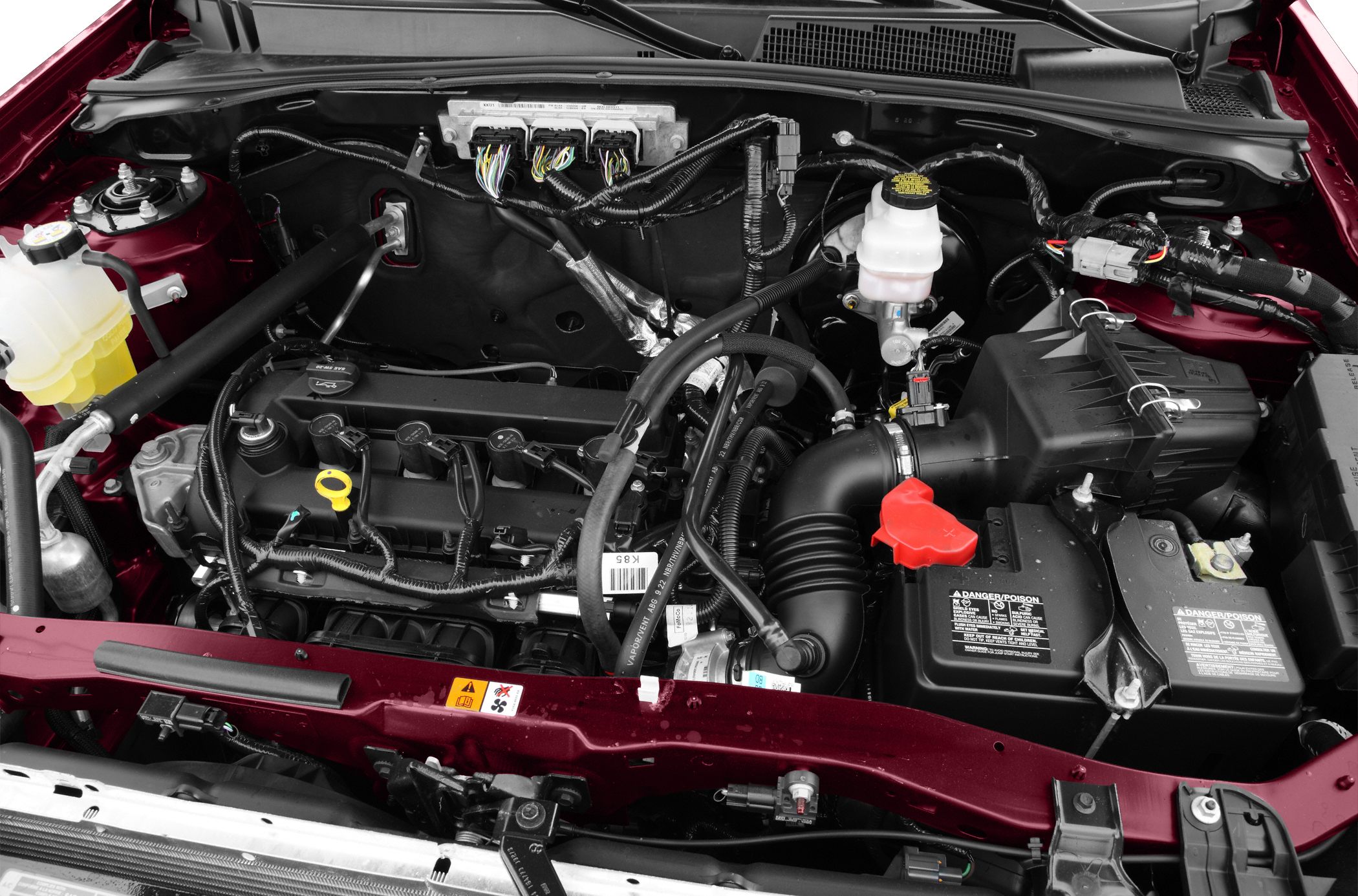 Engine bay with engine, air intake, battery, and wiring harness components