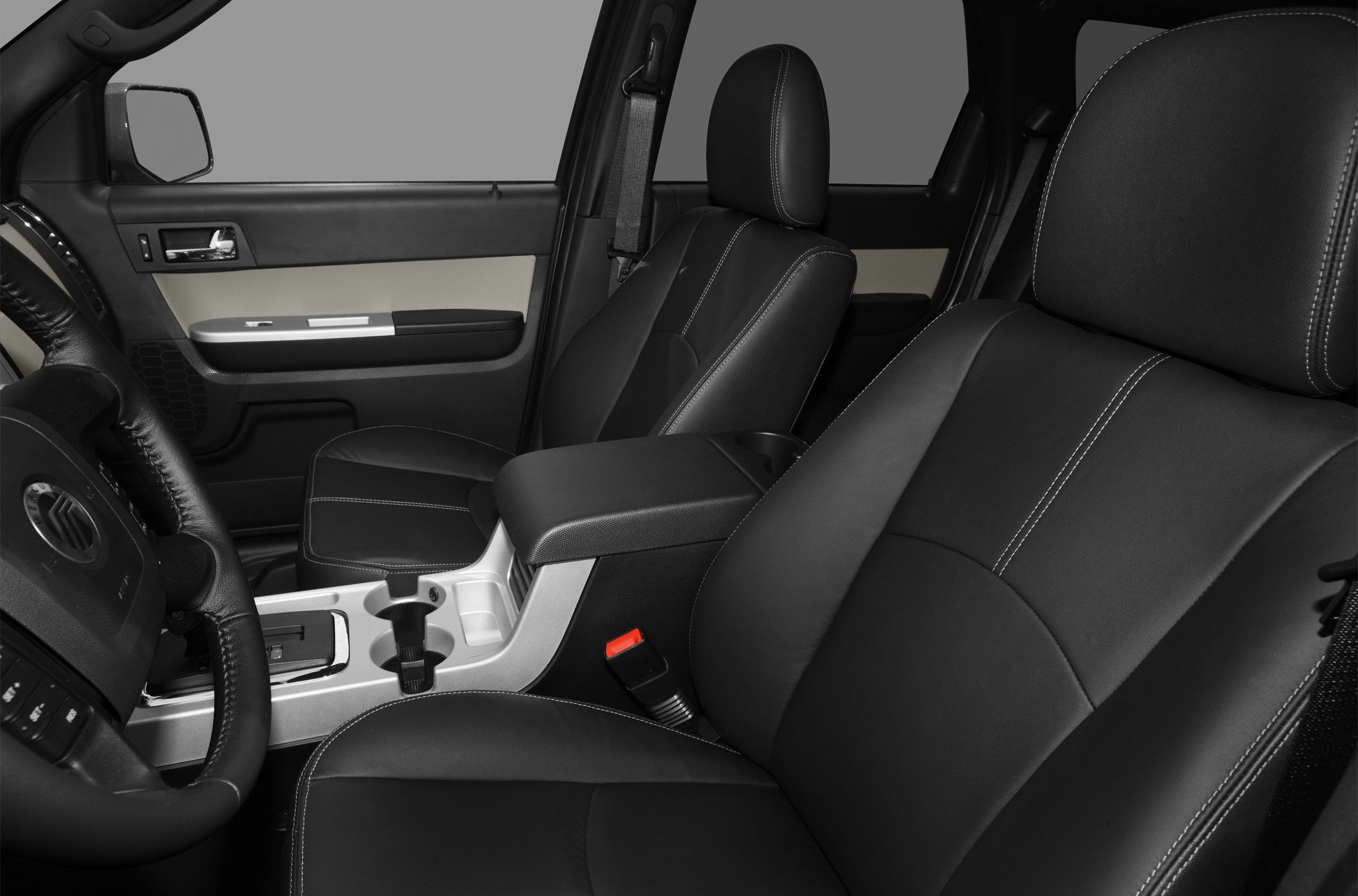 Black leather seats with white stitching and central console with cup holders
