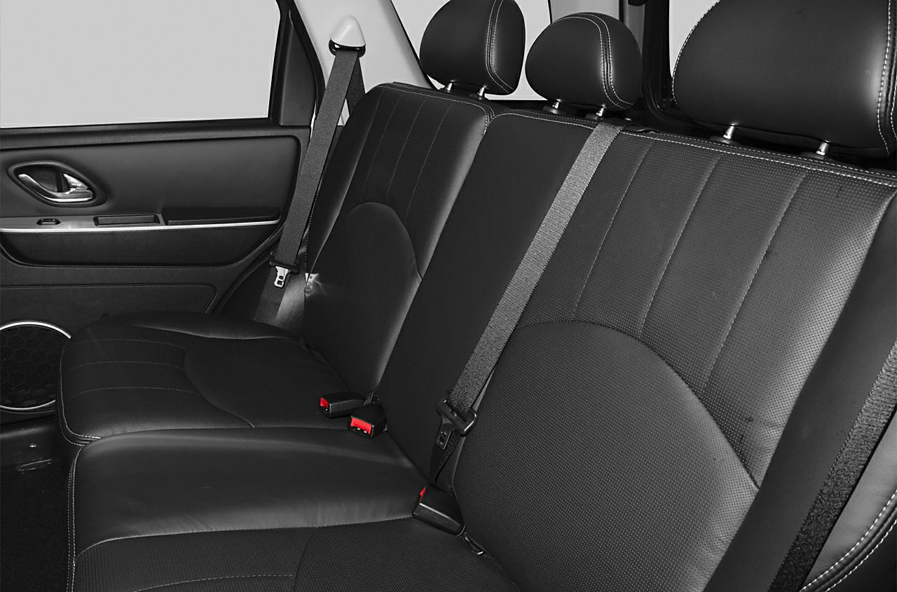 Rear seat interior with black leather upholstery and seat belts