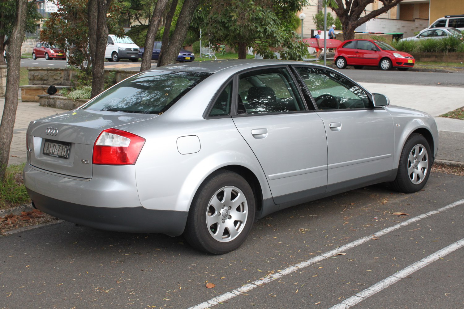 Silver sedan rear side with distinctive tail lights and alloy wheels