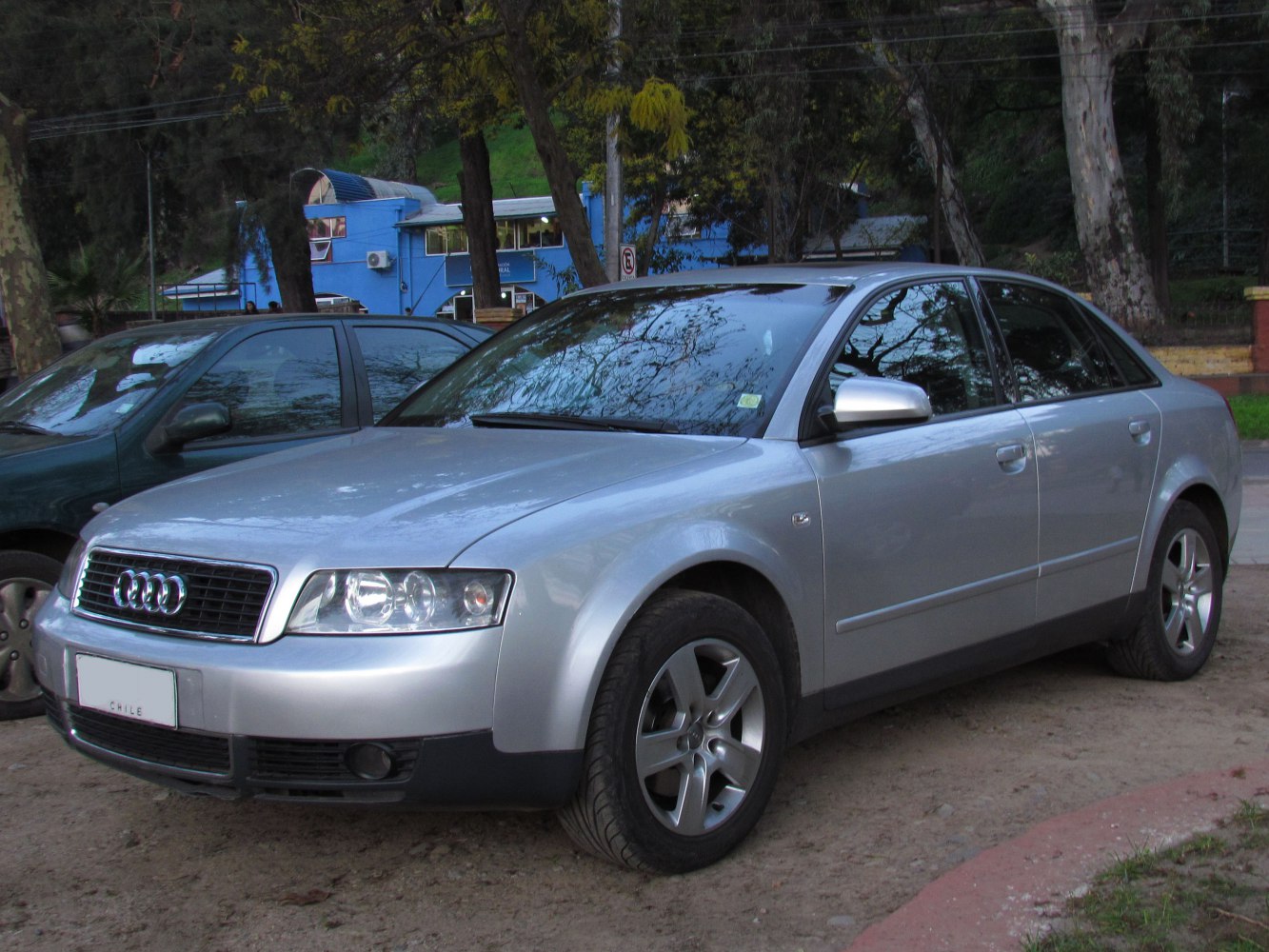 Silver sedan front three-quarter view with distinctive headlights and grille
