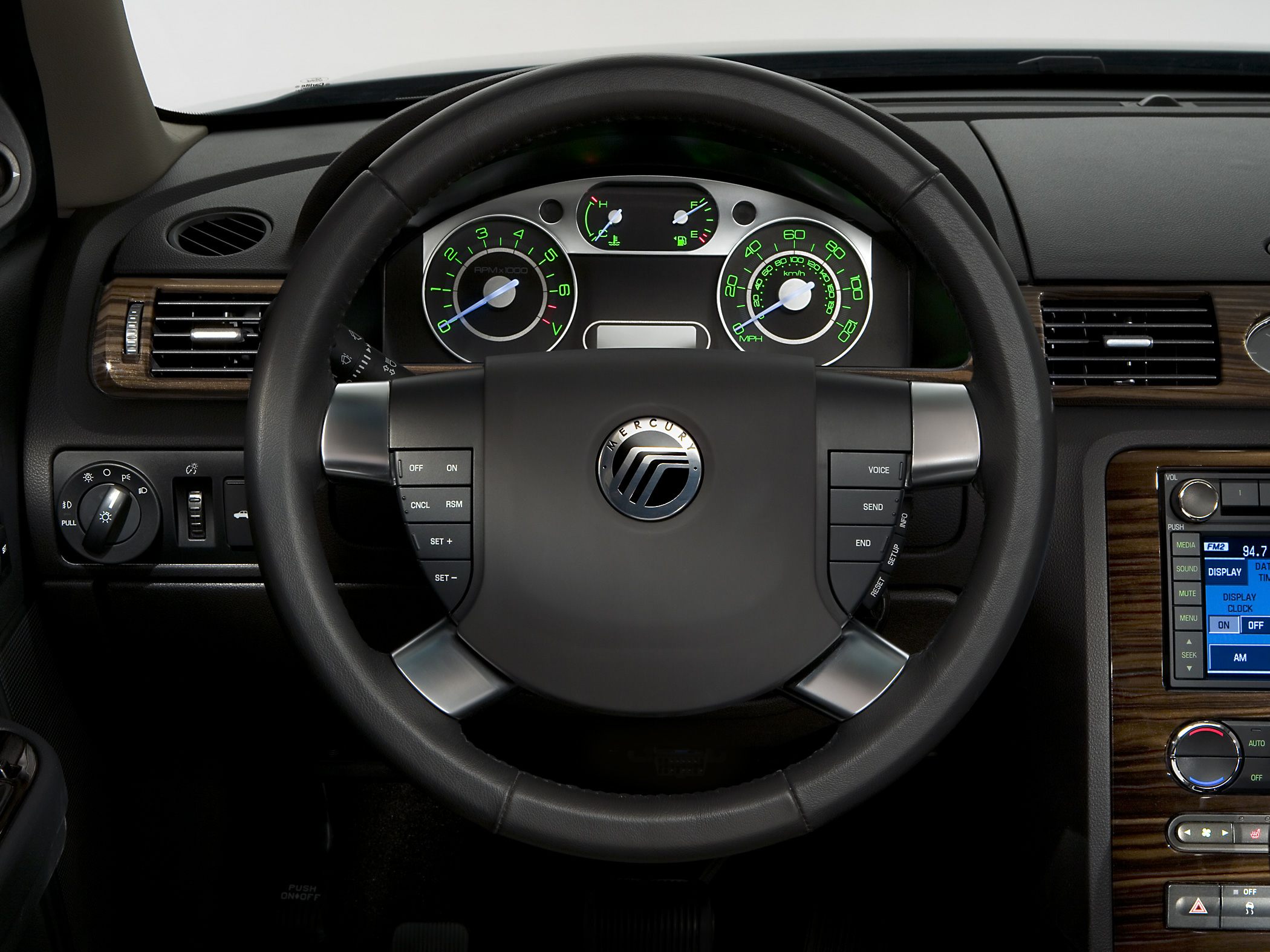 Dashboard with steering wheel, instrument cluster, and wood-trimmed control panels