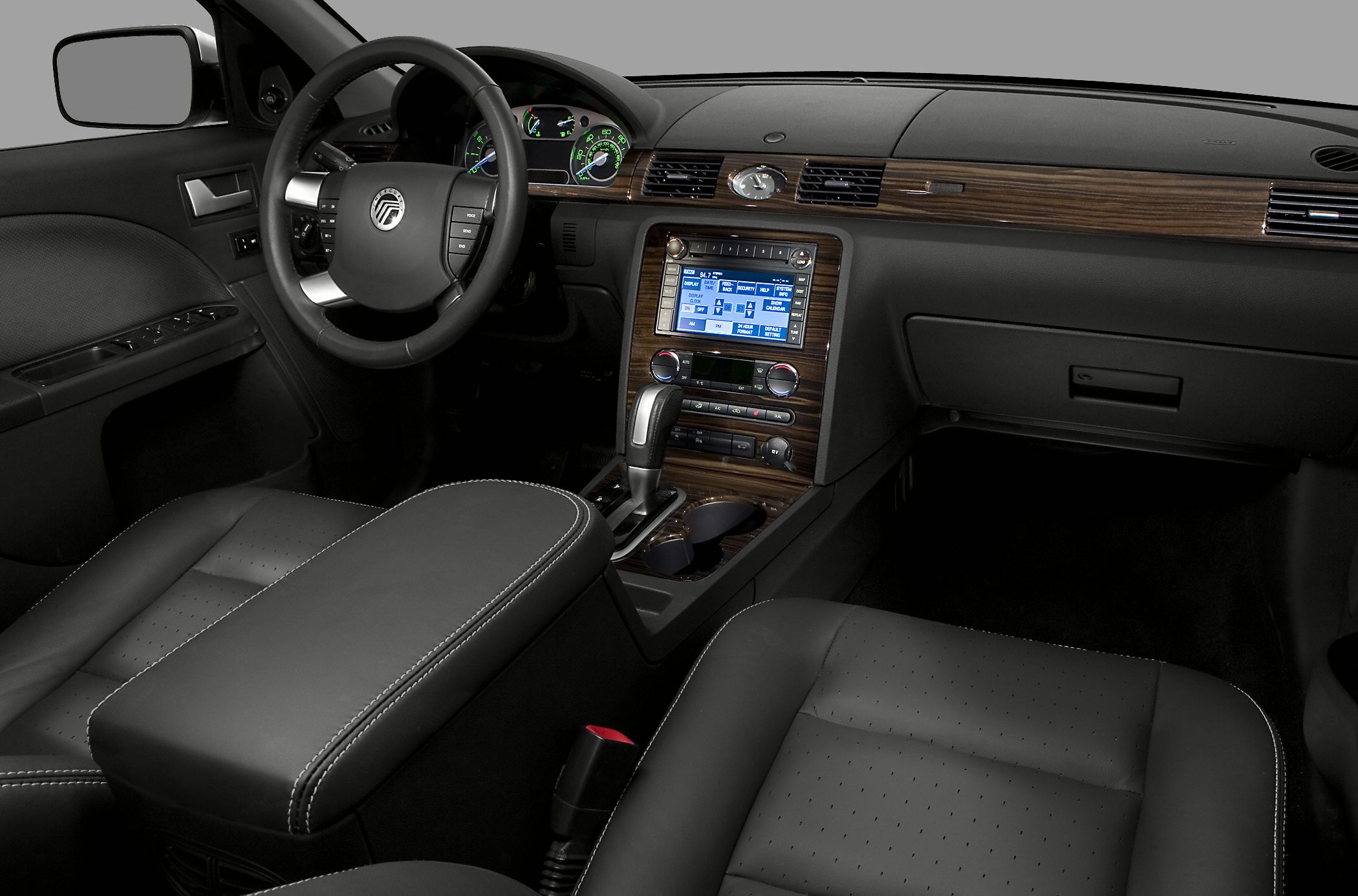 Interior dashboard with wood trim, digital display, leather seats, and automatic gear shift