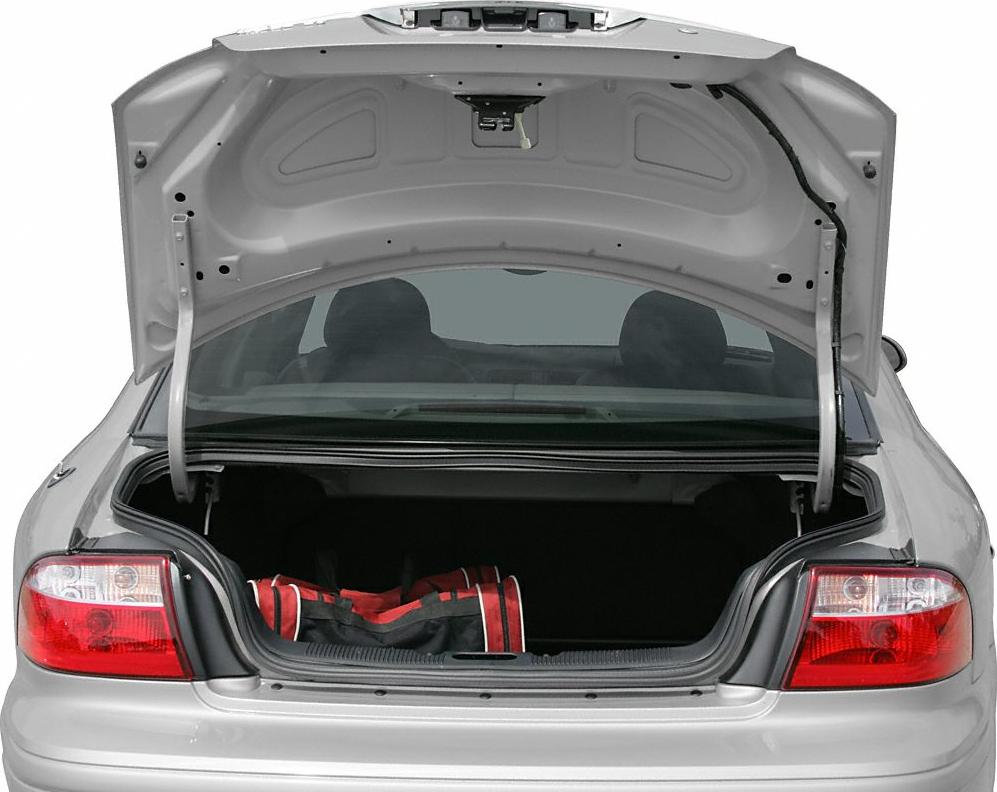 Open trunk and rear taillights of a sedan car with a bag inside