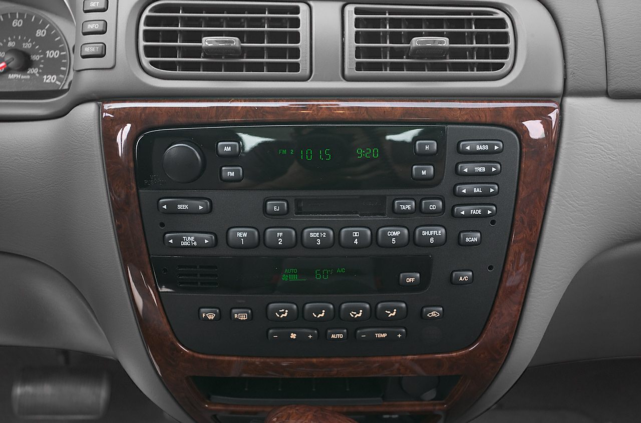 Dashboard center console with audio and climate controls, wood trim