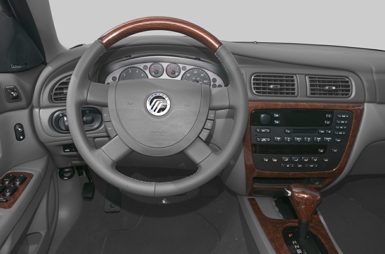 Steering wheel with wood trim, dashboard, and center console controls