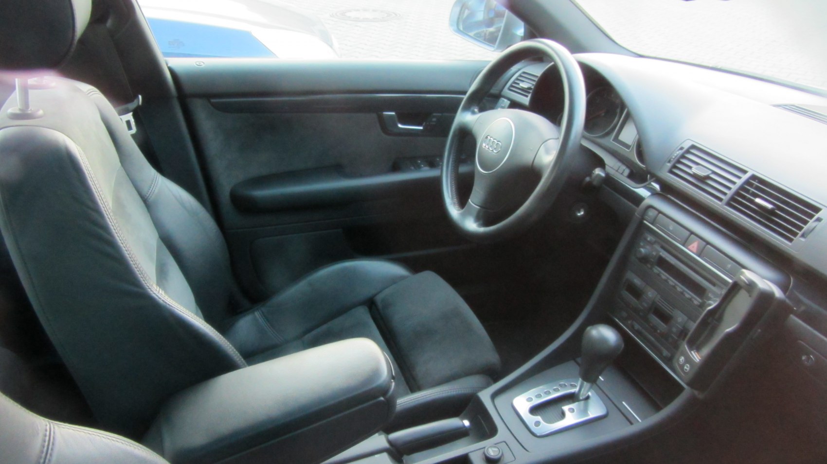 Dashboard, steering wheel, and center console of vintage sedan