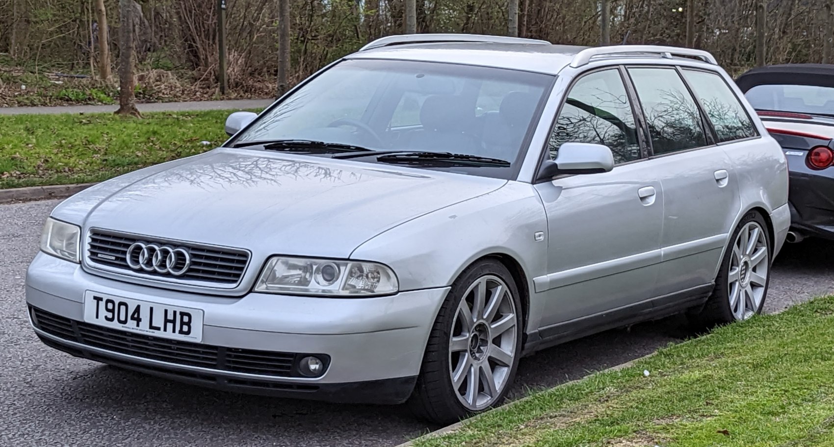 Silver mid-size station wagon with Audi grille and roof rails