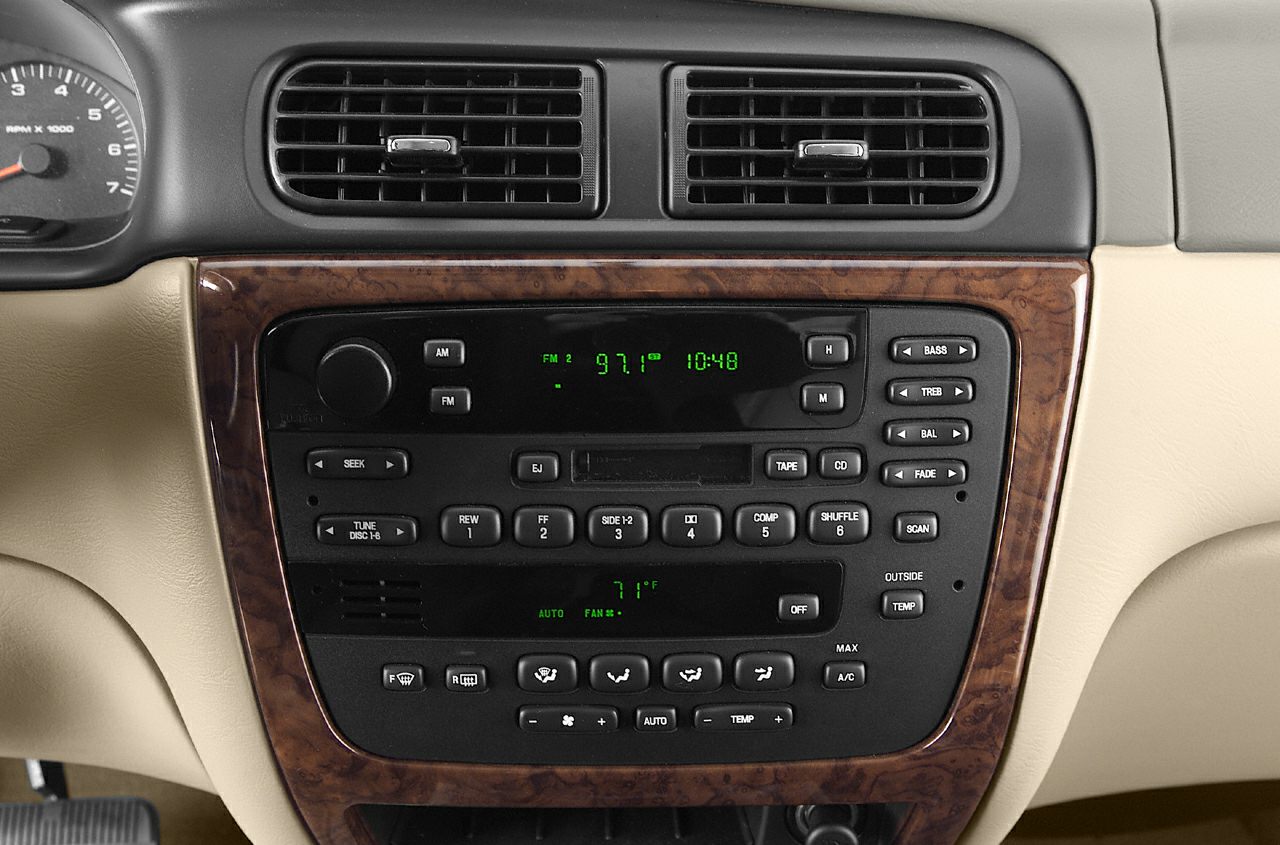 Dashboard with wood trim, radio, and climate controls