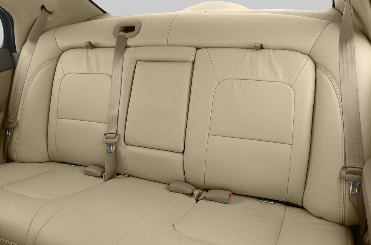 Beige leather rear seats with seat belts and center armrest