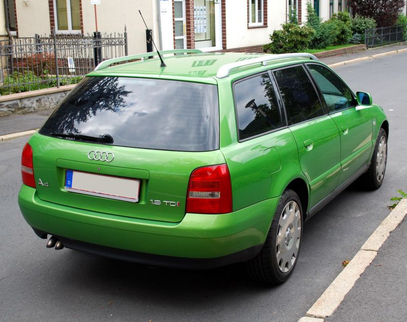 Rear and side view of a green estate car with tinted windows and roof rails