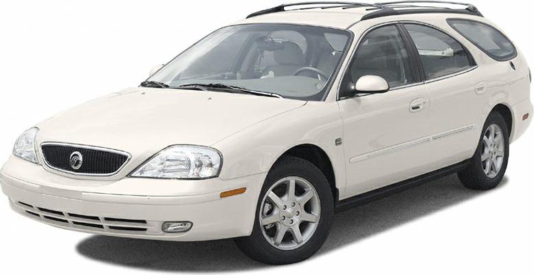 Front side view of a white station wagon with roof rails